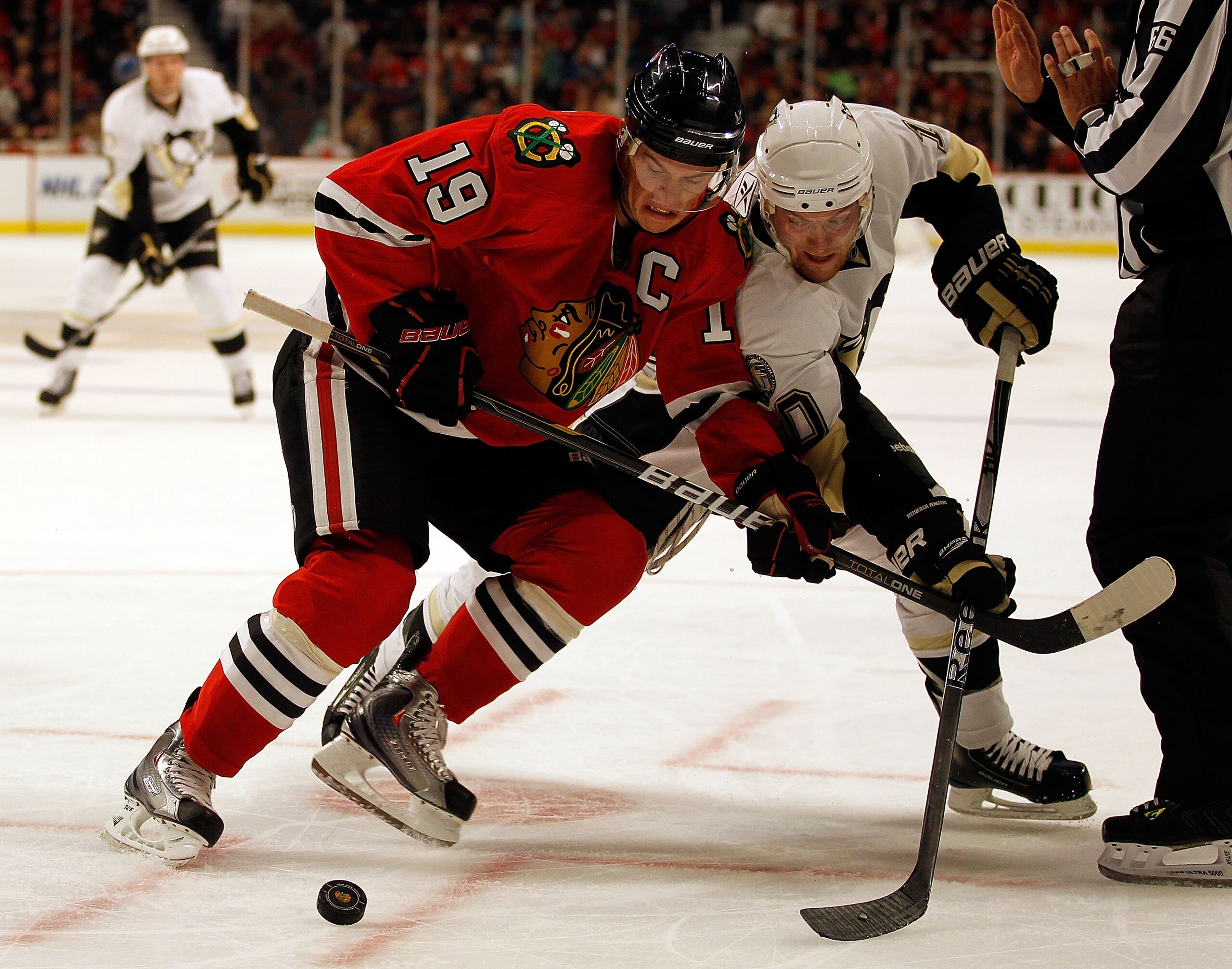 CHICAGO - OCTOBER 01: Jonathan Toews #19 of the Chicago Blackhawks and Mark Letestu #10 of the Pittsburgh Penguins battle for the puck after a face-off during a pre-season game at the United Center on October 1, 2010 in Chicago, Illinois. The Blackhawks d