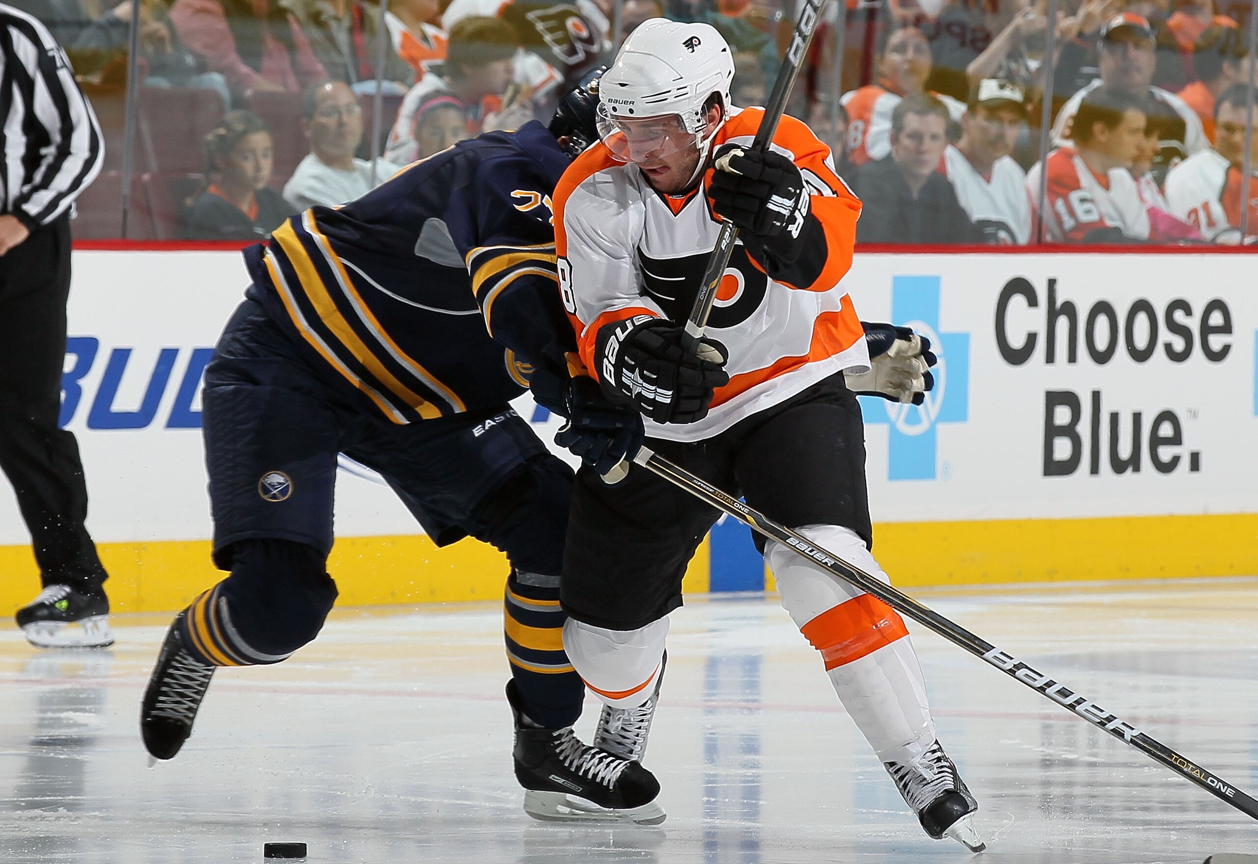 PHILADELPHIA - OCTOBER 01:  Mike Richards #18 of the Philadelphia Flyers makes a move against Shaone Morrisonn #27 of the Buffalo Sabres on October 1, 2010 at Wells Fargo Center in Philadelphia, Pennsylvania.  (Photo by Jim McIsaac/Getty Images)