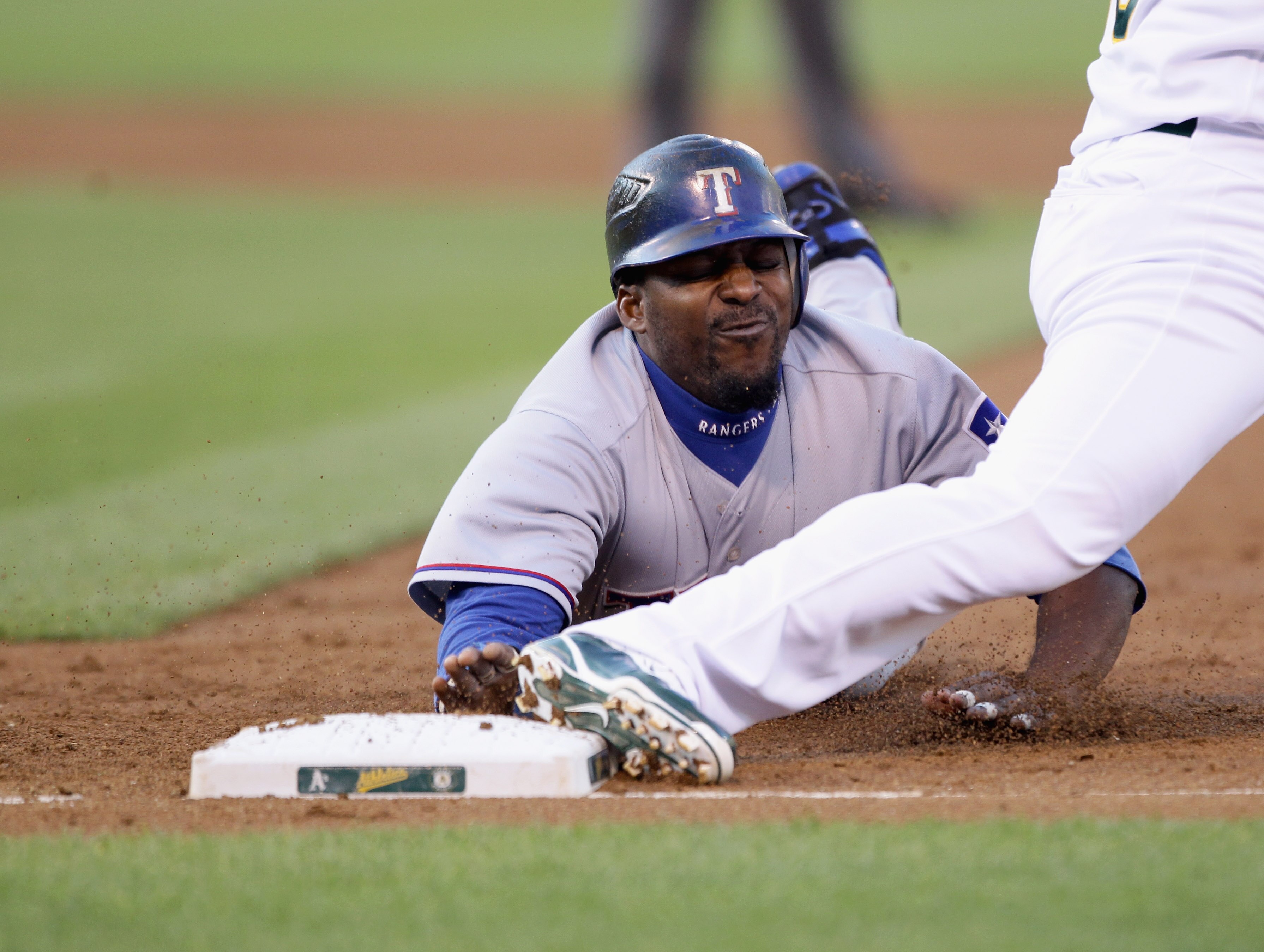 OAKLAND, CA - AUGUST 06:  Vladimir Guerrero #27 of the Texas Rangers is caught off first base for a double play in the second inning of their game against the Oakland Athletics at the Oakland-Alameda County Coliseum on August 6, 2010 in Oakland, Californi