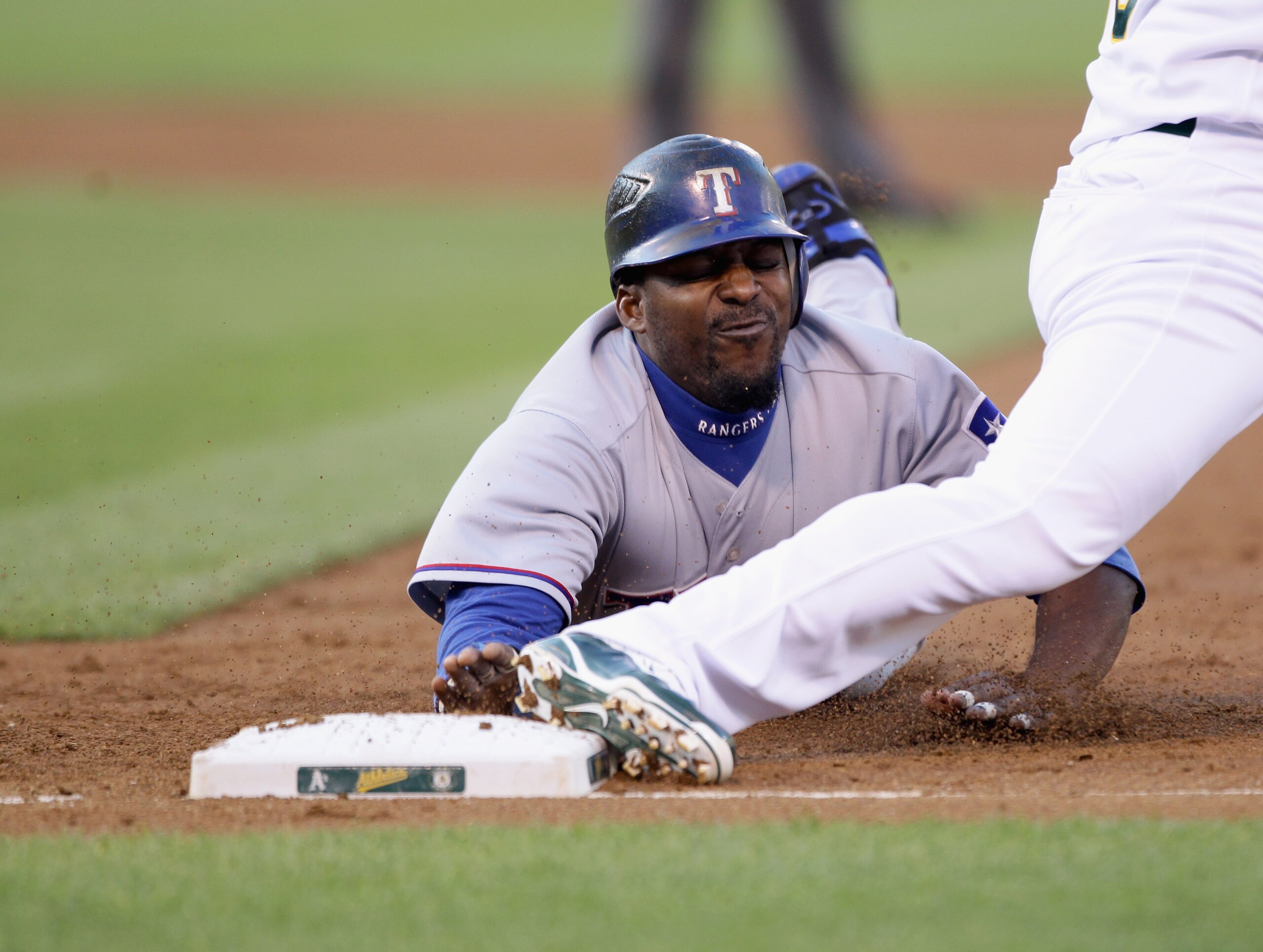 OAKLAND, CA - AUGUST 06:  Vladimir Guerrero #27 of the Texas Rangers is caught off first base for a double play in the second inning of their game against the Oakland Athletics at the Oakland-Alameda County Coliseum on August 6, 2010 in Oakland, Californi