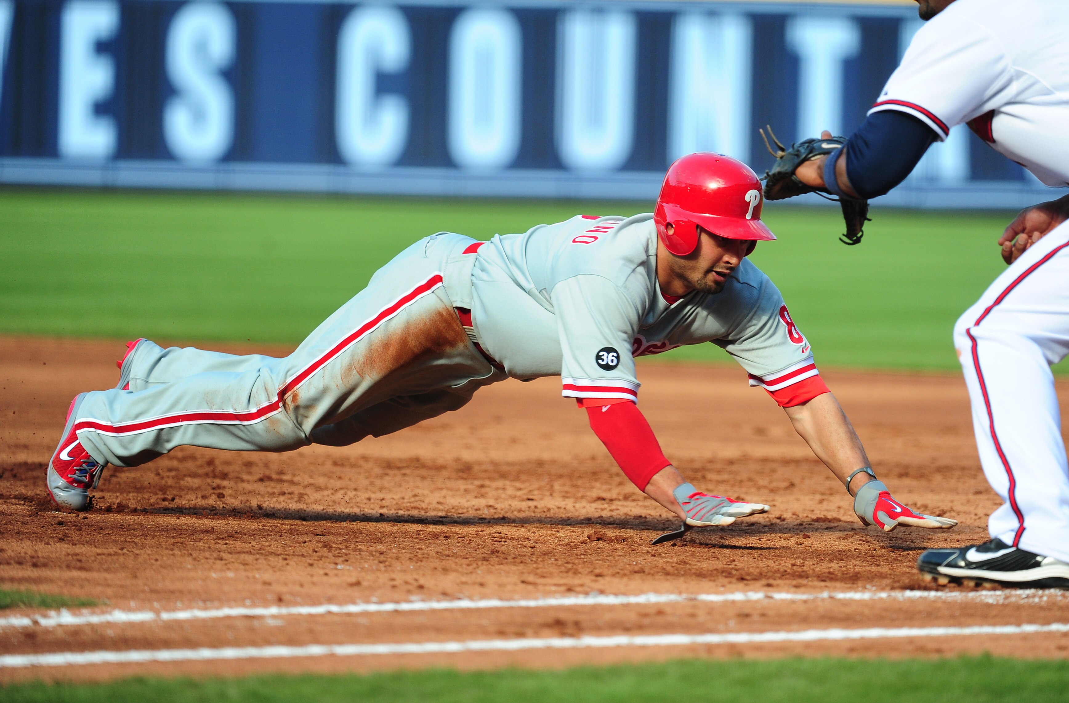 ATLANTA - OCTOBER 2: Shane Victorino #8 of the Philadelphia Phillies dives back to first base against the Atlanta Braves at Turner Field on October 2, 2010 in Atlanta, Georgia.  (Photo by Scott Cunningham/Getty Images)