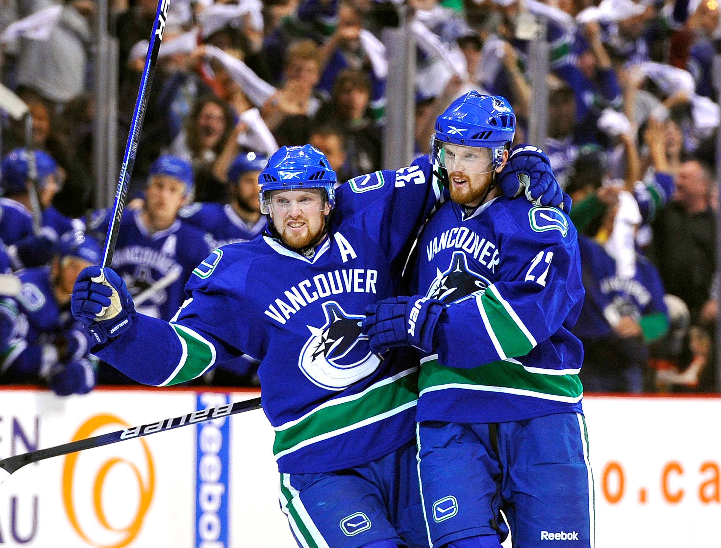 VANCOUVER, CANADA - MAY 7:  Daniel Sedin #22 and Henrik Sedin #33 of the Vancouver Canucks celebrate after Daniel Sedin scored against the Chicago Blackhawks during the first period in Game Four of the Western Conference Semifinals during the 2010 NHL Sta
