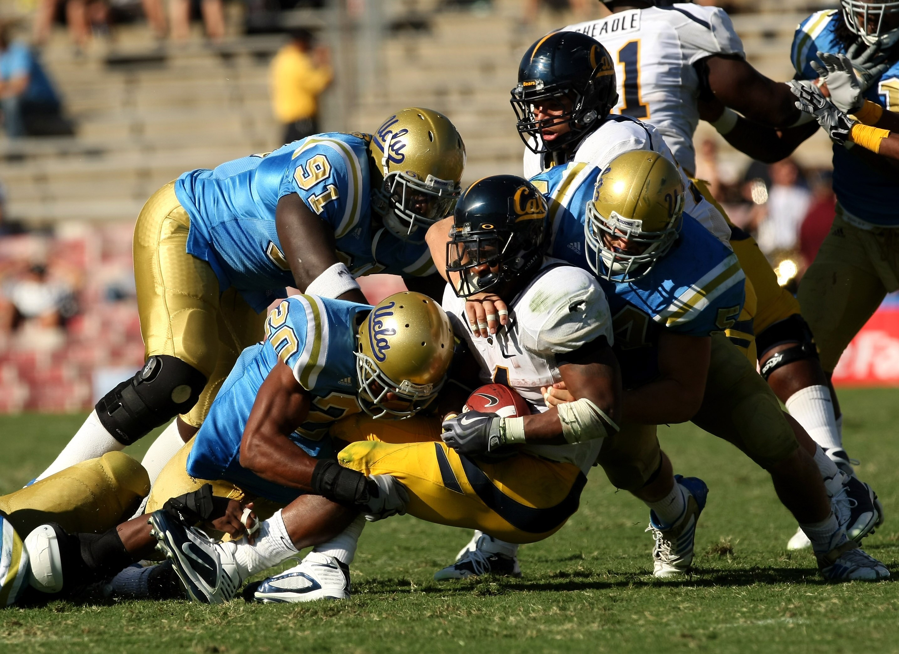 PASADENA, CA - OCTOBER 17: Running back Jahvid Best #4 of the California Golden Bears is brought down by UCLA Bruins defenders Glenn Love #20, Reginald Stokes #91, and Kyle Bosworth #54 on October 17, 2009 at the Rose Bowl in Pasadena, California. Cal PASADENA, CA - OCTOBER 17: Running back Jahvid Best #4 of the California Golden Bears is brought down by UCLA Bruins defenders Glenn Love #20, Reginald Stokes #91, and Kyle Bosworth #54 on October 17, 2009 at the Rose Bowl in Pasadena, California. Cal