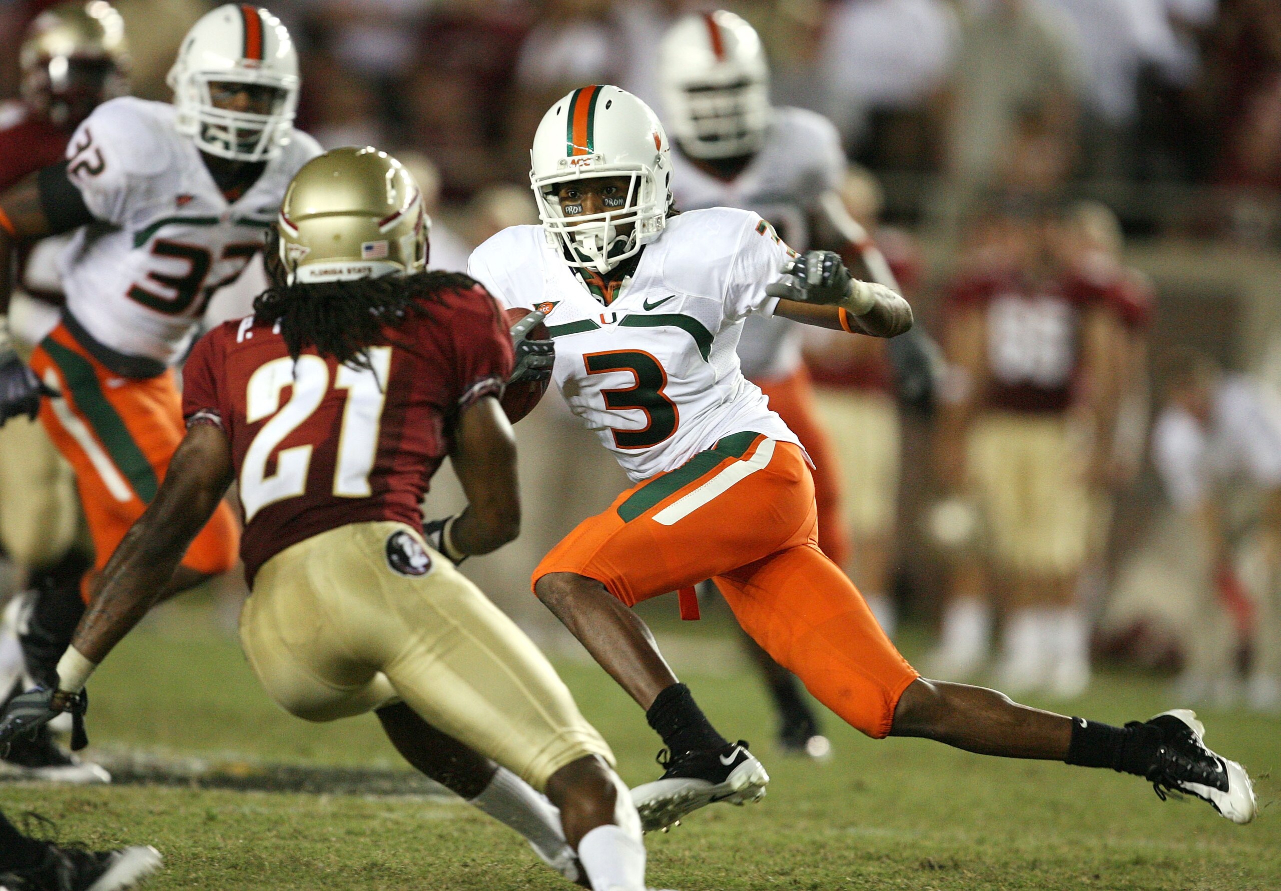 TALLAHASSEE, FL - SEPTEMBER 07:  Wide receiver Travis Benjamin #3 of the Miami Hurricanes tries to avoid a tackle attempt by cornerback Patrick Robinson #21 of the Florida State Seminoles at Doak Campbell Stadium on September 7, 2009 in Tallahassee, Flori