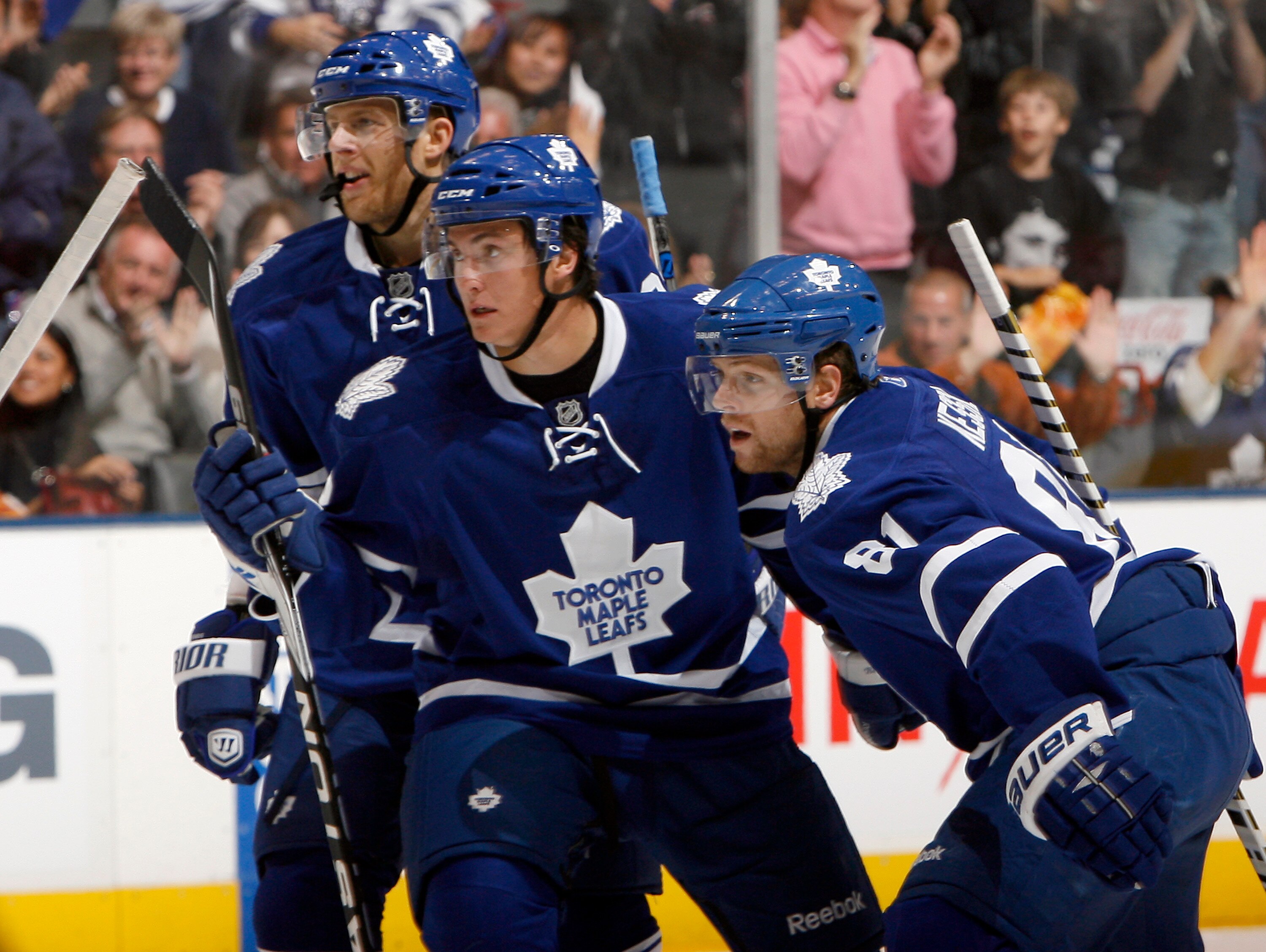 TORONTO - OCTOBER 2: Kris Versteeg #32, Tyler Bozak #42 and Phil Kessel #81 of the Toronto Maple Leafs celebrate a goal by teammate Tomas Kaberle #15 against the Detroit Red Wings during a preseason NHL game at the Air Canada Centre October 2, 2010 in Tor
