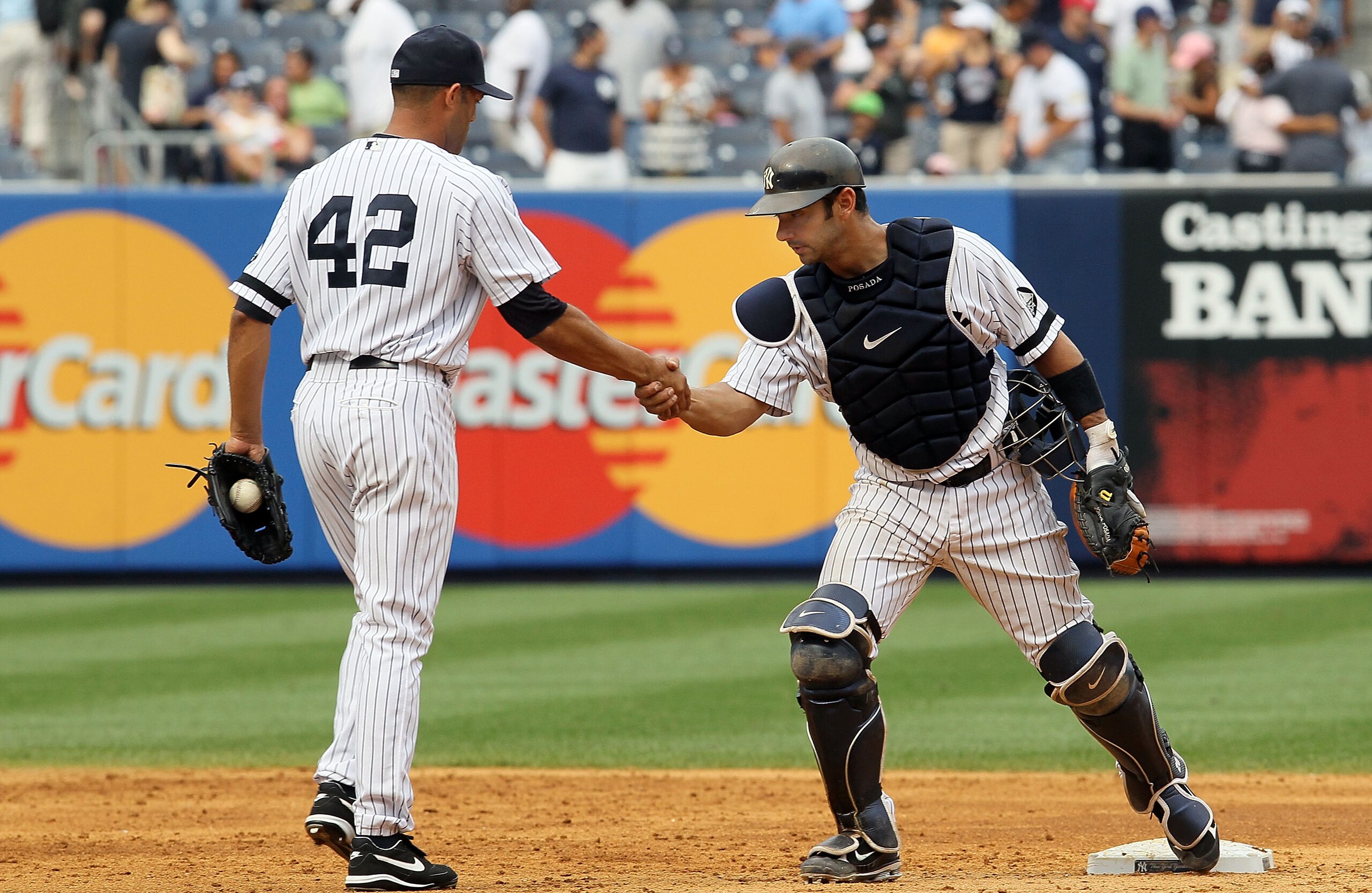 NEW YORK - AUGUST 21:  Mariano Rivera #42 and Jorge Posada #20 of the New York Yankees celebrate after defeating the Seattle Mariners on August 21, 2010 at Yankee Stadium in the Bronx borough of New York City. The Yankees defeated the Mariners 9-5.  (Phot