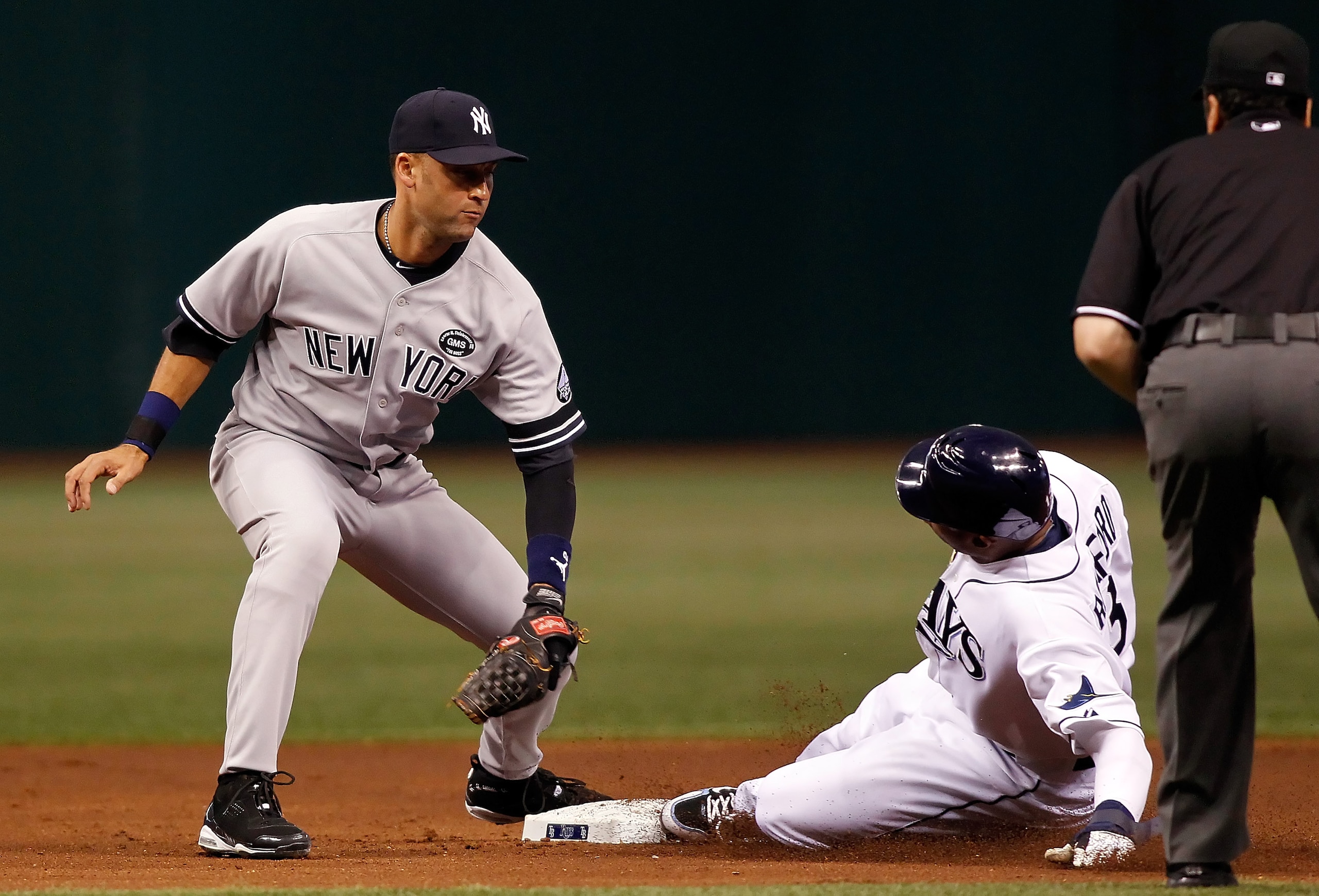 ST. PETERSBURG - JULY 31: Outfielder Carl Crawford #13 of the Tampa Bay Rays steals his 400th career base as shortstop Derek Jeter #2 of the New York Yankees is late with the tag during the game at Tropicana Field on July 31, 2010 in St. Petersburg, Flor ST. PETERSBURG - JULY 31: Outfielder Carl Crawford #13 of the Tampa Bay Rays steals his 400th career base as shortstop Derek Jeter #2 of the New York Yankees is late with the tag during the game at Tropicana Field on July 31, 2010 in St. Petersburg, Flor
