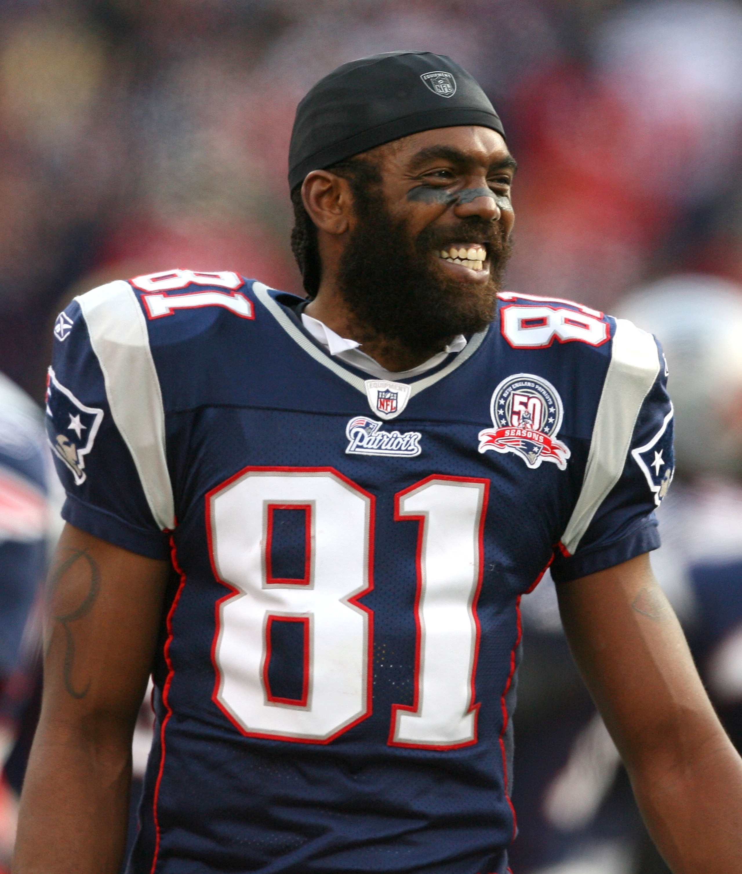 FOXBORO, MA - DECEMBER 27: Randy Moss #81 of the New England Patriots reacts on the sideline after he caught his third touchdown pass of the day against the Jacksonville Jaguars in the fourth quarter at Gillette Stadium on December 27, 2009 in Foxboro, Ma