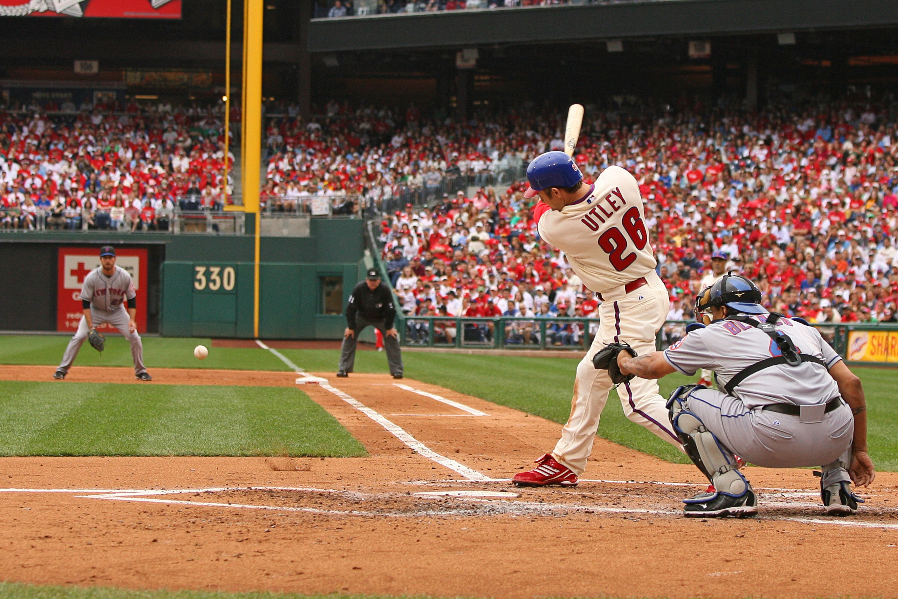 PHILADELPHIA - SEPTEMBER 26: Second baseman Chase Utley #26 of the Philadelphia Phillies hits a ground ball during a game against the New York Mets at Citizens Bank Park on September 26, 2010 in Philadelphia, Pennsylvania. (Photo by Hunter Martin/Getty Im