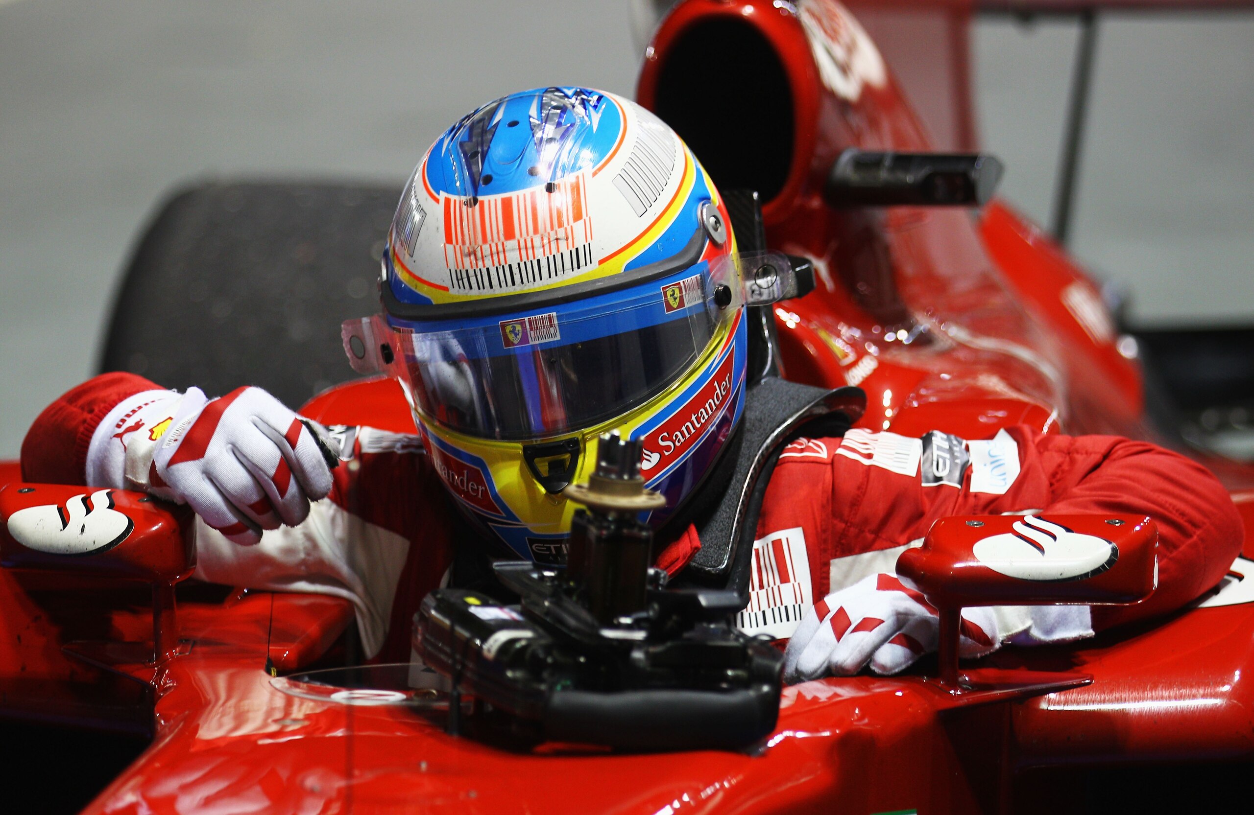 SINGAPORE - SEPTEMBER 26:  Fernando Alonso of Spain and Ferrari celebrates in parc ferme after winning the Singapore Formula One Grand Prix at the Marina Bay Street Circuit on September 26, 2010 in Singapore.  (Photo by Paul Gilham/Getty Images)