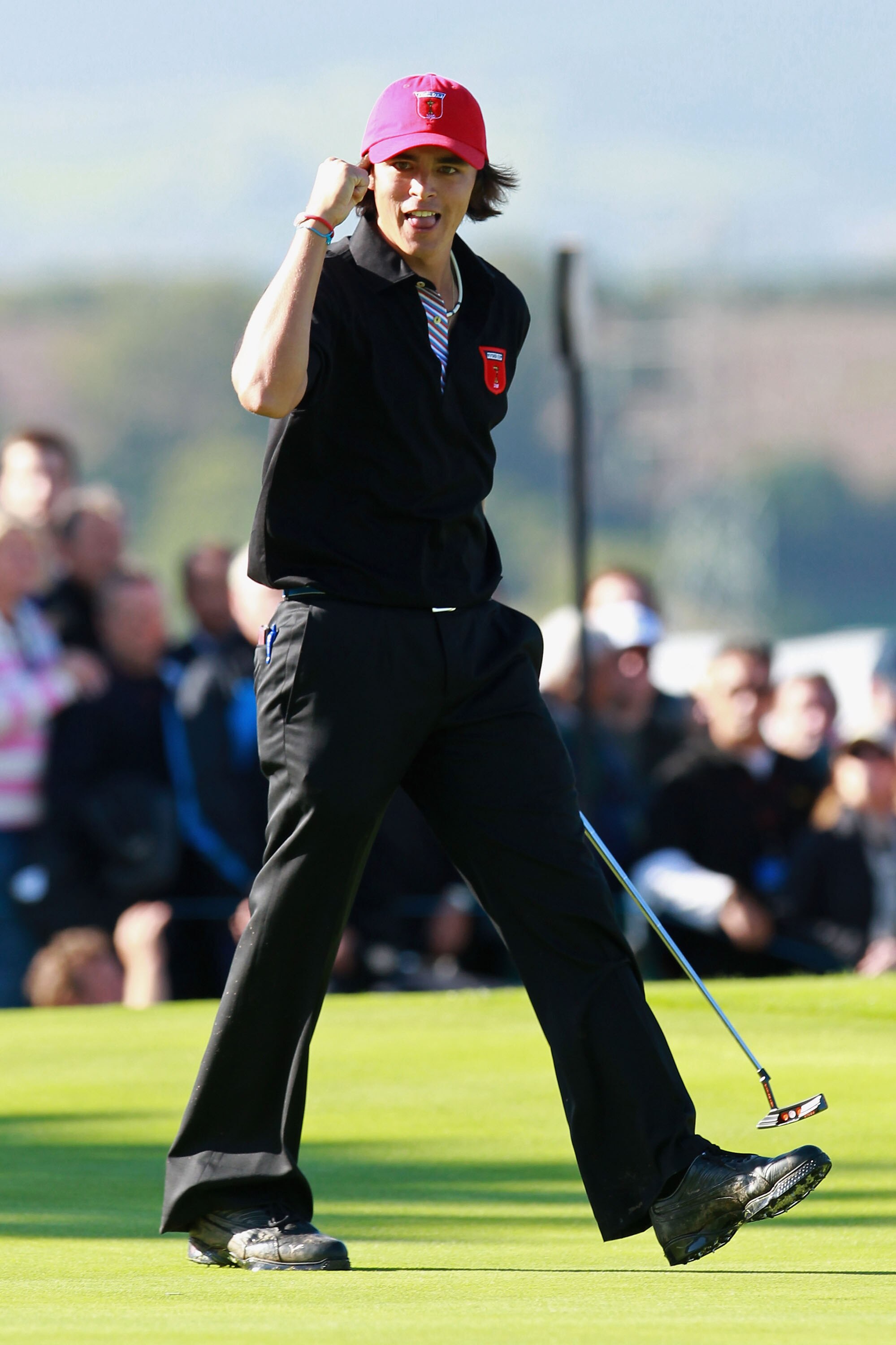 NEWPORT, WALES - OCTOBER 04:  Rickie Fowler of the USA celebrates on the 18th green after halving his match in the singles matches during the 2010 Ryder Cup at the Celtic Manor Resort on October 4, 2010 in Newport, Wales.  (Photo by Andrew Redington/Getty