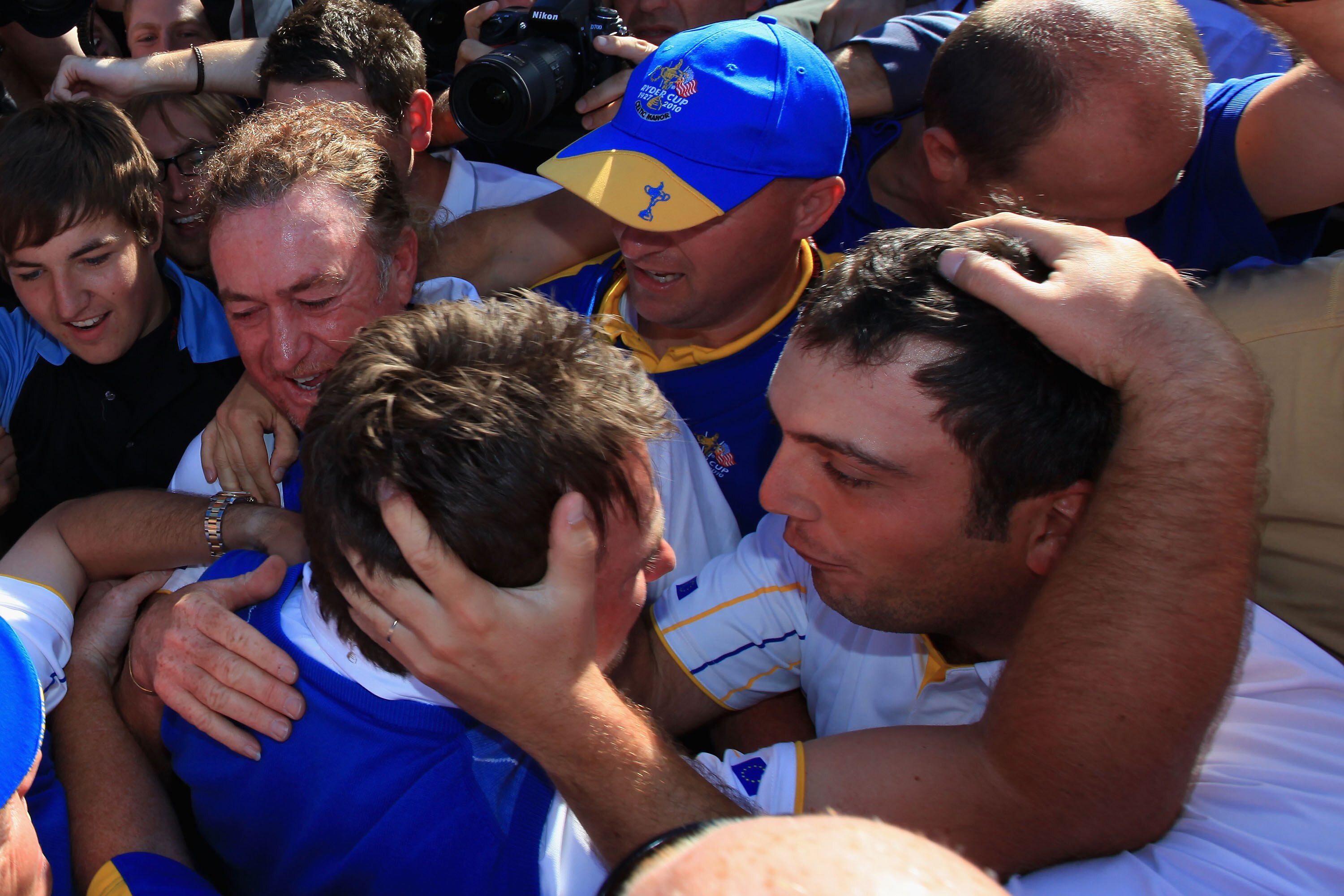 NEWPORT, WALES - OCTOBER 04:  Graeme McDowell of Europe (C) celebrates with Miguel Angel Jimenez (L) and Francesco Molinari after McDowell's 3&1 win to secure victory for the European team on the 17th green at the end of the singles matches during the 201