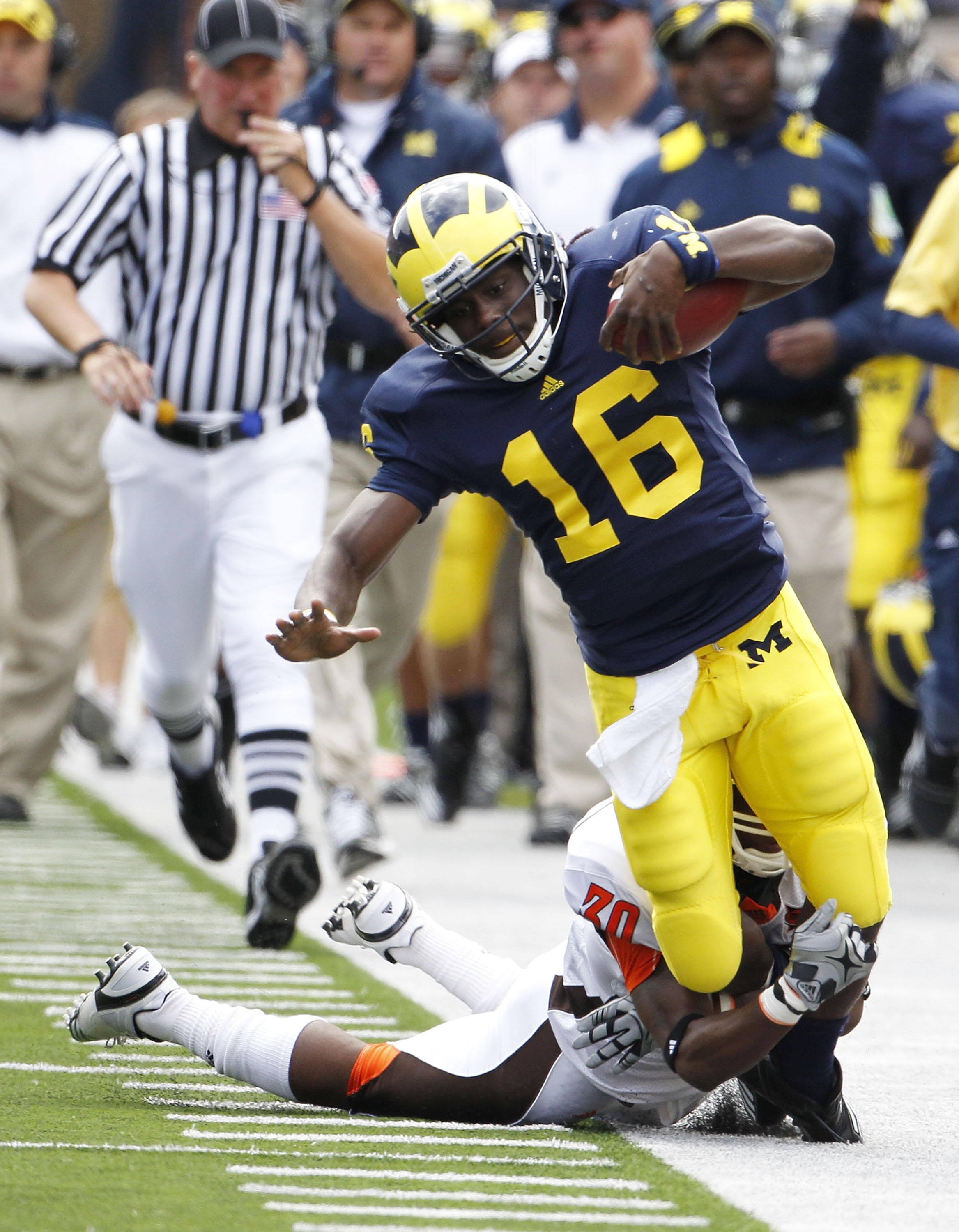 ANN ARBOR, MI - SEPTEMBER 25: Cameron Truss #30 of Bowling Green tackles Denard Robison #16 of the Michigan Wolverines on September 25, 2010 at Michigan Stadium in Ann Arbor, Michigan. Robison left the game after this play with a reported leg injury. (P ANN ARBOR, MI - SEPTEMBER 25: Cameron Truss #30 of Bowling Green tackles Denard Robison #16 of the Michigan Wolverines on September 25, 2010 at Michigan Stadium in Ann Arbor, Michigan. Robison left the game after this play with a reported leg injury. (P