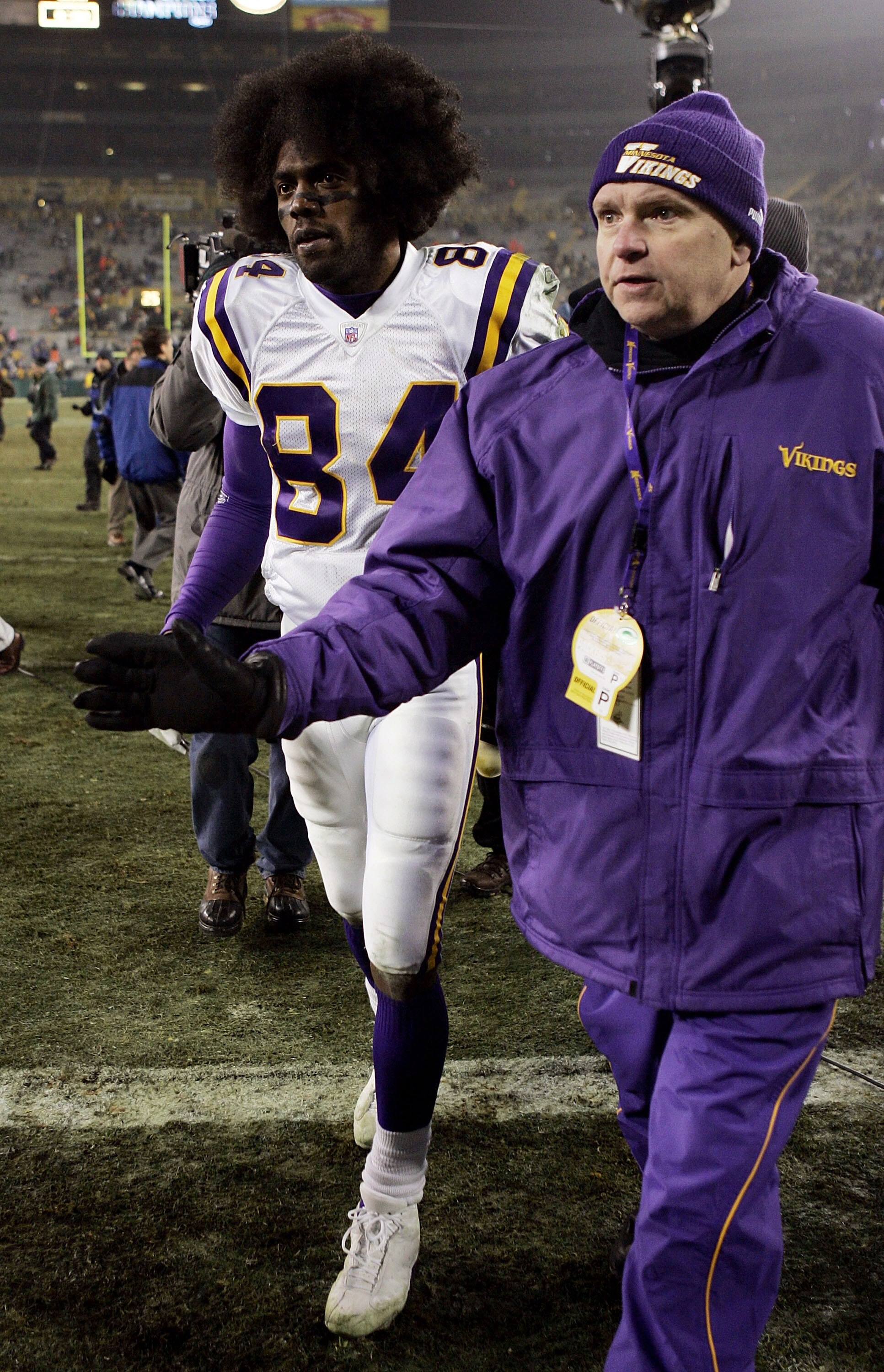 GREEN BAY, WI - JANUARY 9:  Wide receiver Randy Moss #84 of the Minnesota Vikings is escorted off the field after the Vikings defeated the Green Bay Packers during the NFC wild-card game at Lambeau Field January 9, 2005 in Green Bay, Wisconsin. The Viking