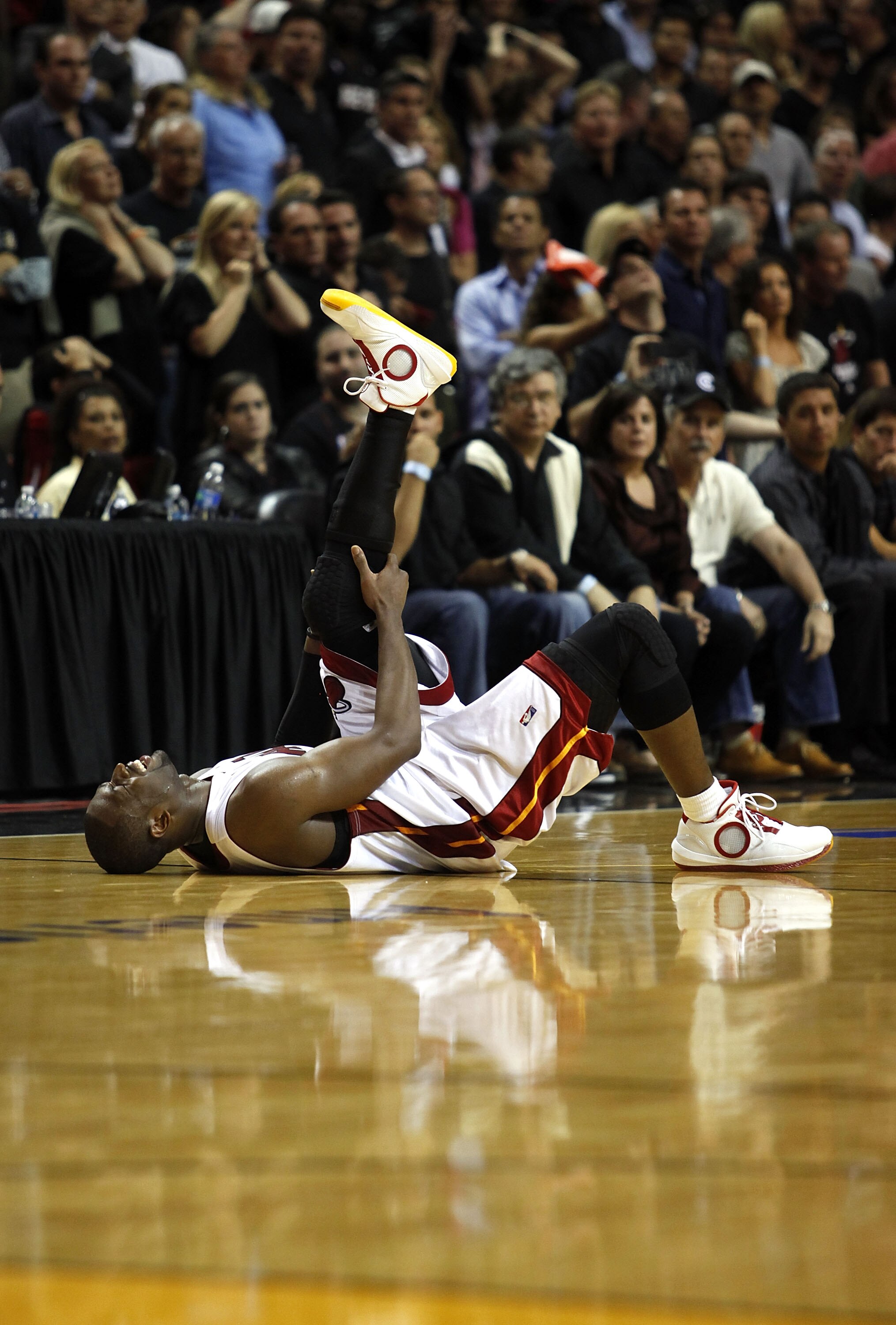 MIAMI - APRIL 23: Guard Dwyane Wade #3 of the Miami Heat stays on the floor injured during a 100-98 loss to the Boston Celtics in Game Three of the Eastern Conference Quarterfinals during the 2010 NBA Playoffs at American Airlines Arena on April 23, 2010 MIAMI - APRIL 23: Guard Dwyane Wade #3 of the Miami Heat stays on the floor injured during a 100-98 loss to the Boston Celtics in Game Three of the Eastern Conference Quarterfinals during the 2010 NBA Playoffs at American Airlines Arena on April 23, 2010