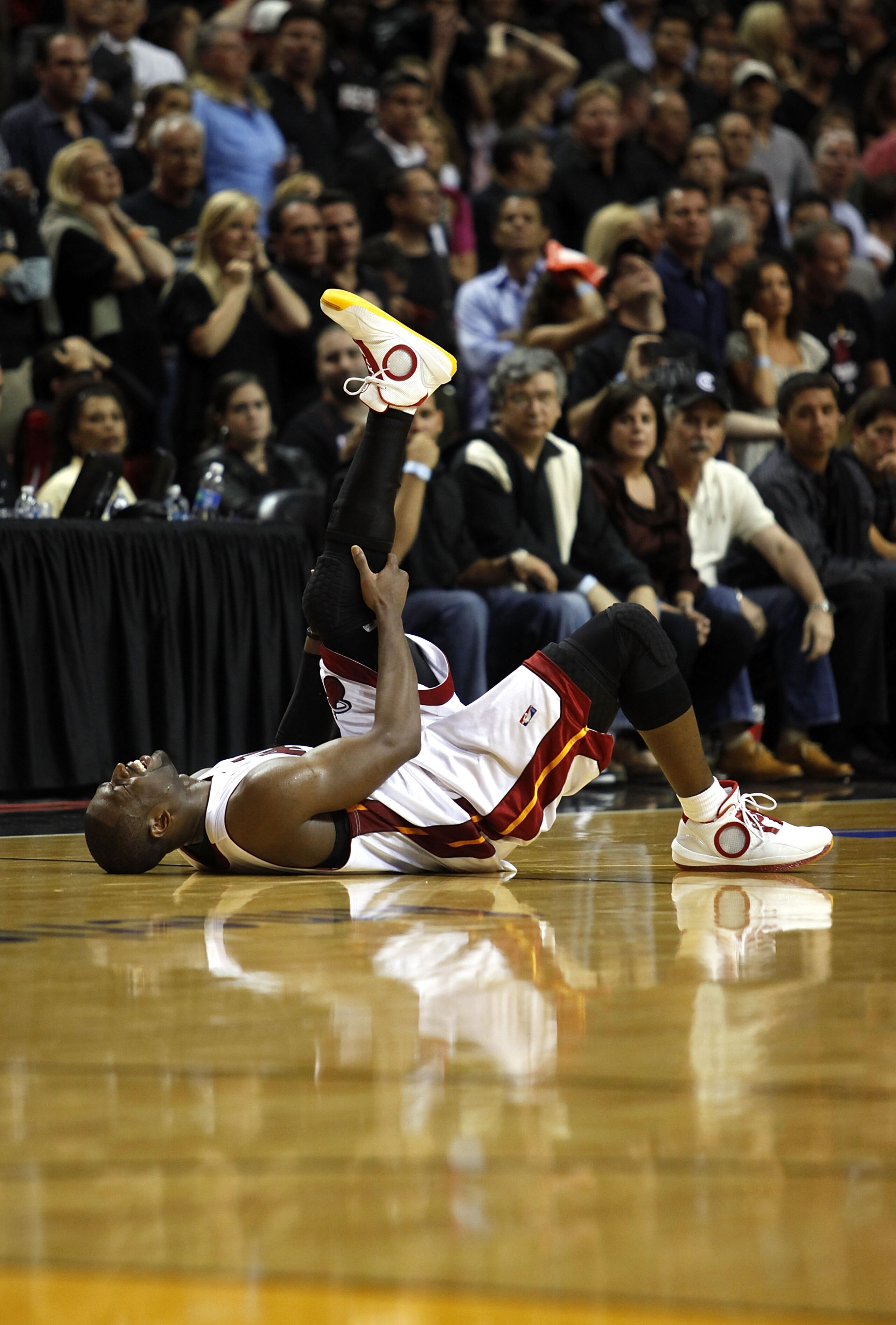 MIAMI - APRIL 23:  Guard Dwyane Wade #3 of the Miami Heat stays on the floor injured during a 100-98 loss to the Boston Celtics in Game Three of the Eastern Conference Quarterfinals during the 2010 NBA Playoffs at American Airlines Arena on April 23, 2010
