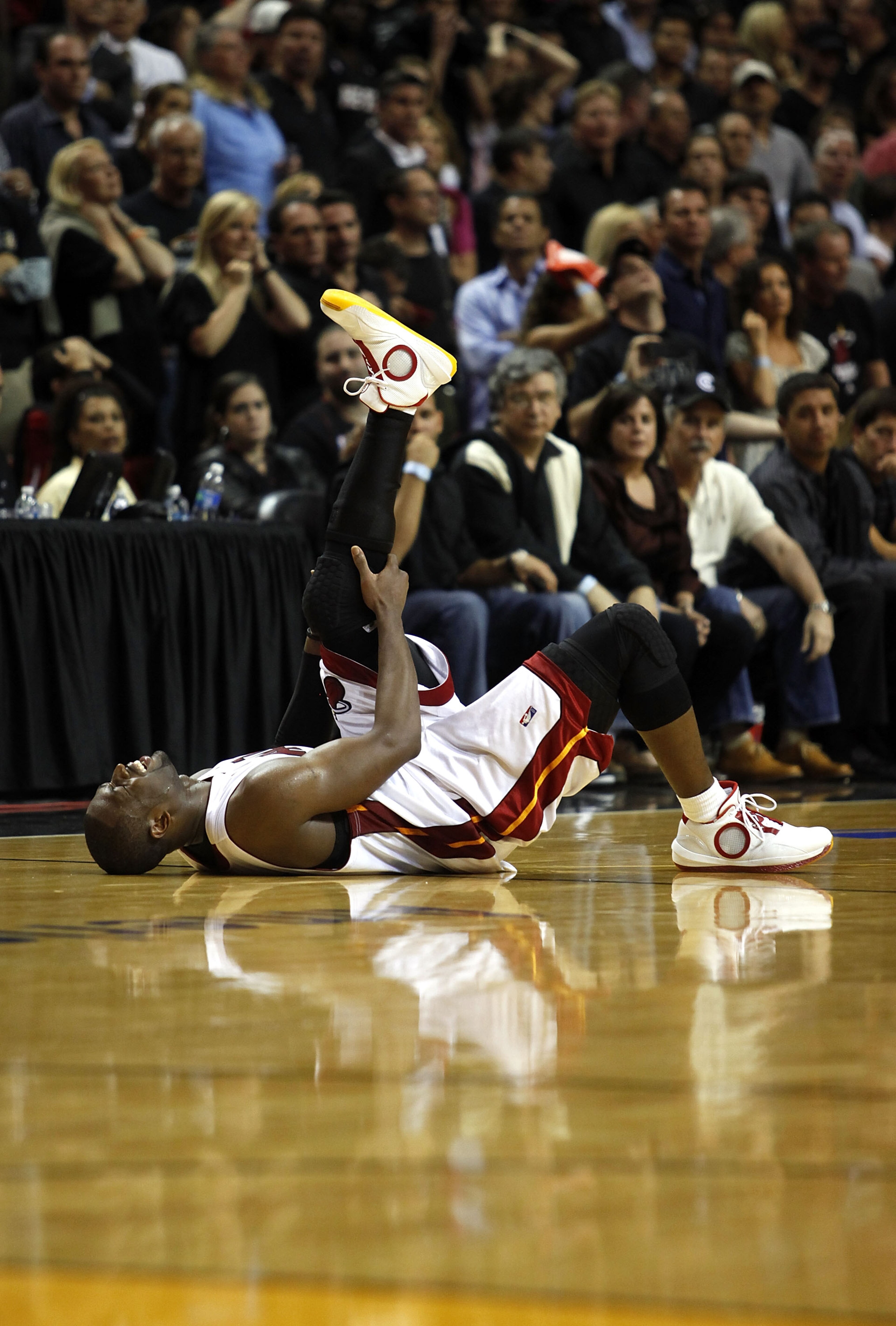 MIAMI - APRIL 23:  Guard Dwyane Wade #3 of the Miami Heat stays on the floor injured during a 100-98 loss to the Boston Celtics in Game Three of the Eastern Conference Quarterfinals during the 2010 NBA Playoffs at American Airlines Arena on April 23, 2010