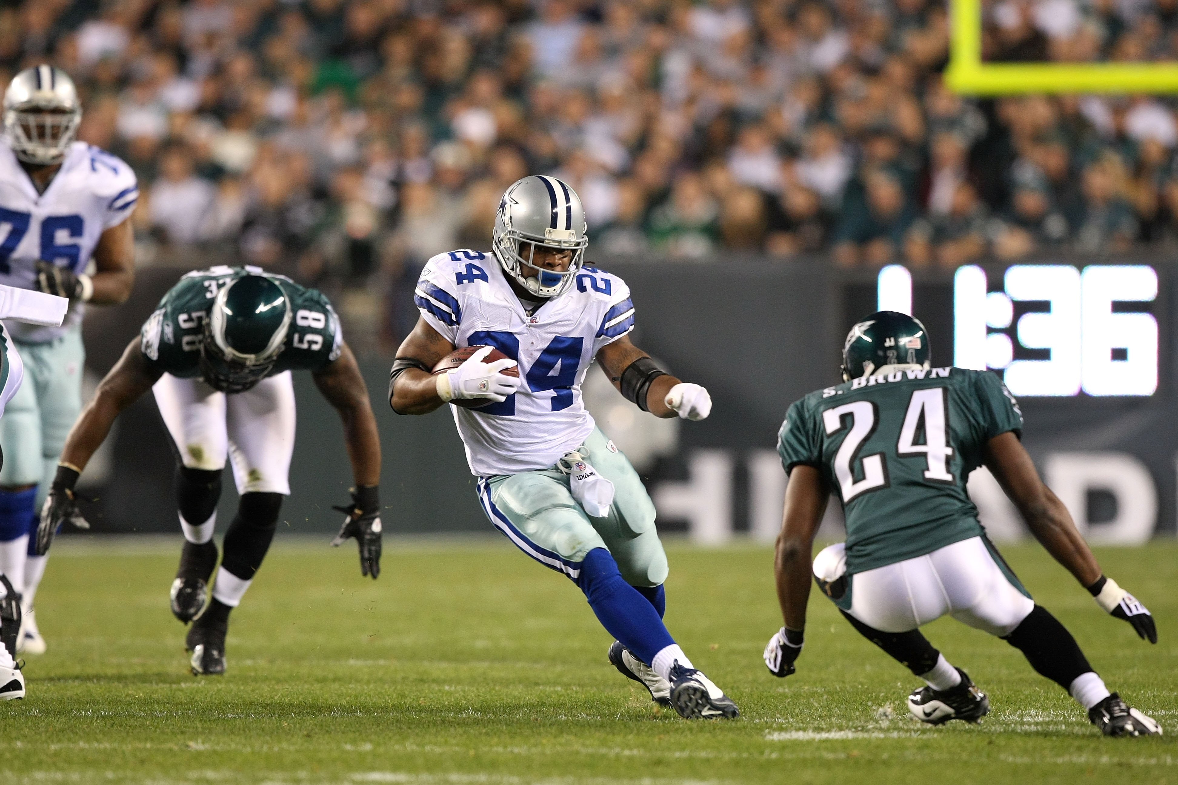 PHILADELPHIA - NOVEMBER 08:  Marion Barber #24 of the Dallas Cowboys runs the ball against Sheldon Brown #24 and Trent Cole #58 of the Philadelphia Eagles at Lincoln Financial Field on November 8, 2009 in Philadelphia, Pennsylvania.  (Photo by Al Bello/Ge