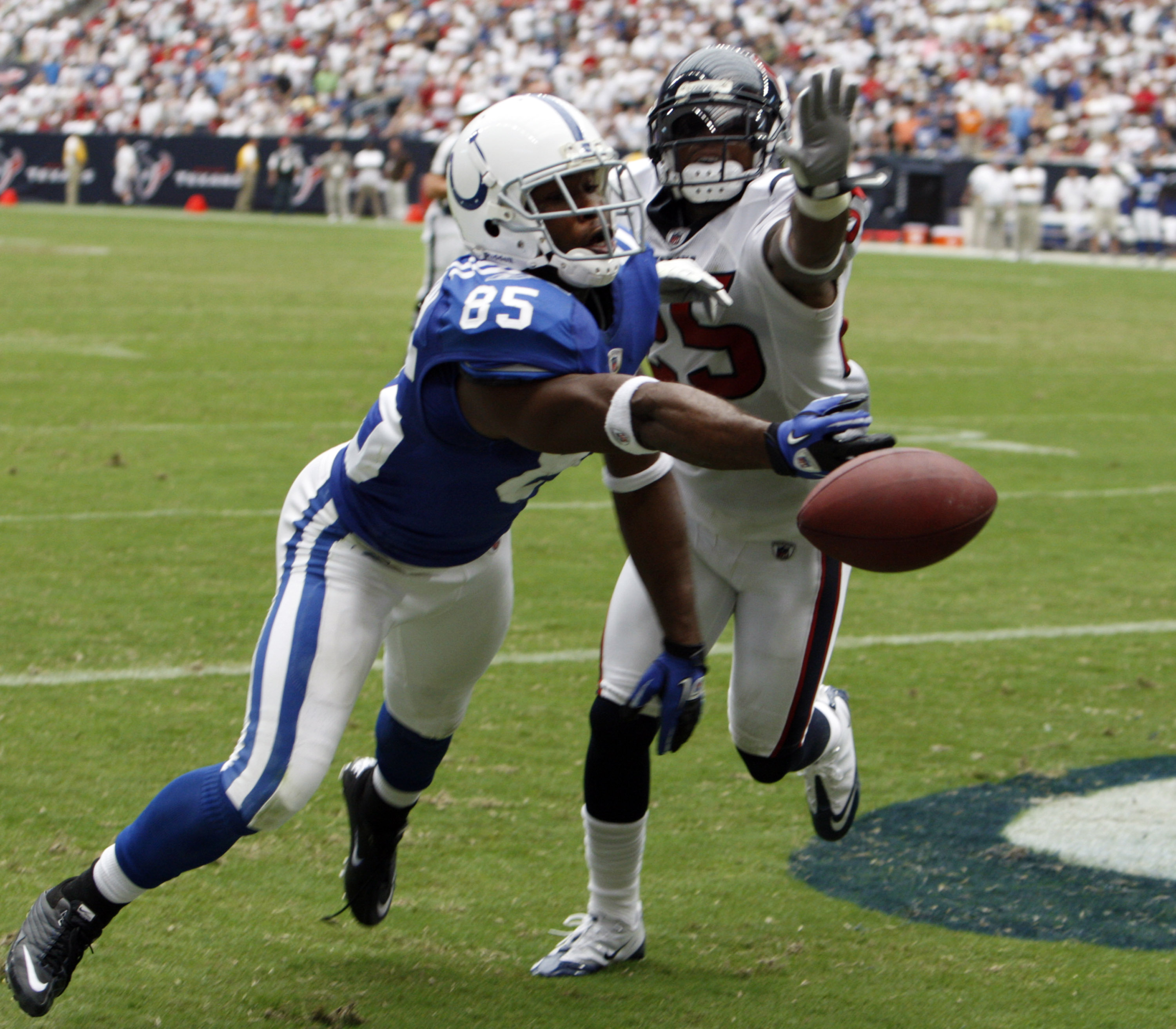 HOUSTON - SEPTEMBER 12:  Wide receiver Pierre Garcon #85 of the Indianapolis Colts can't come up with the catch as cornerback Kareem Jackson #25 of the Houston Texans defends on the play during the NFL season opener at Reliant Stadium on September 12, 201