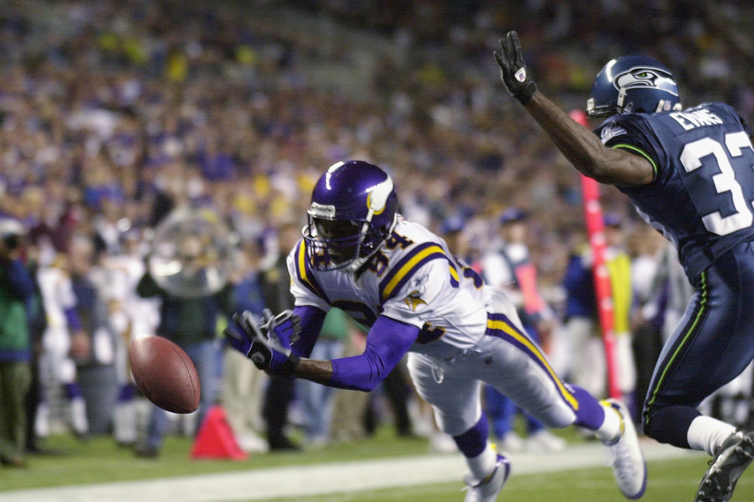 SEATTLE - SEPTEMBER 29:  Randy Moss #84 of the Minnesota Vikings drops the pass in the end zone against Doug Evans #33 of the Seattle Seahawks during the game on September 29, 2002 at Seahawks Stadium in Seattle, Washington.  The Seahawks defeated the Vik