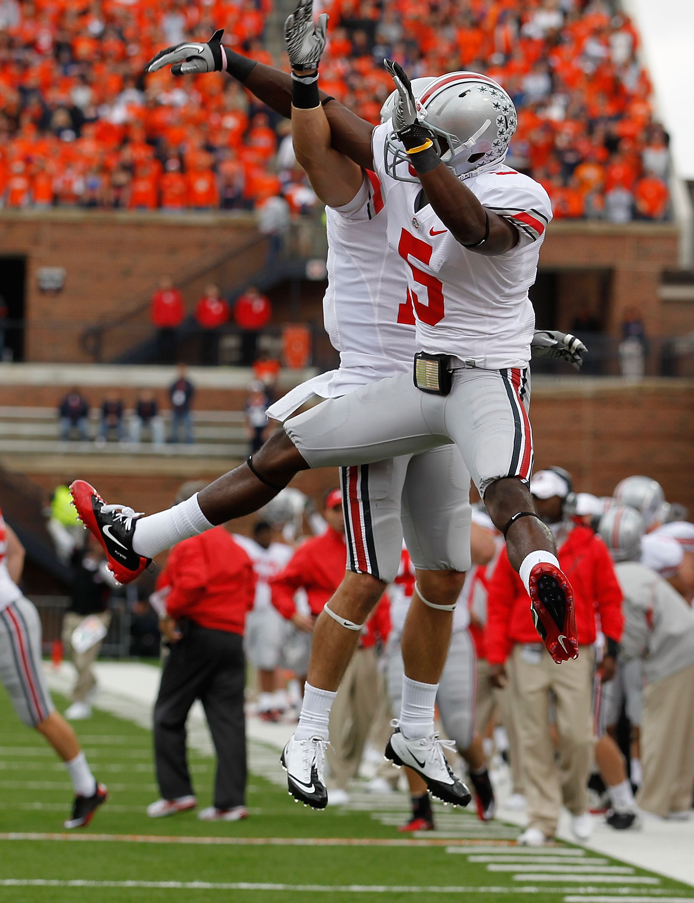 CHAMPAIGN, IL - OCTOBER 02: Dane Sanzenbacher #12 of the Ohio State Buckeyes celebrates catching touchdown pass with teammate Taurian Washington #5 against the Illinois Fighting Illini at Memorial Stadium on October 2, 2010 in Champaign, Illinois. Ohio St