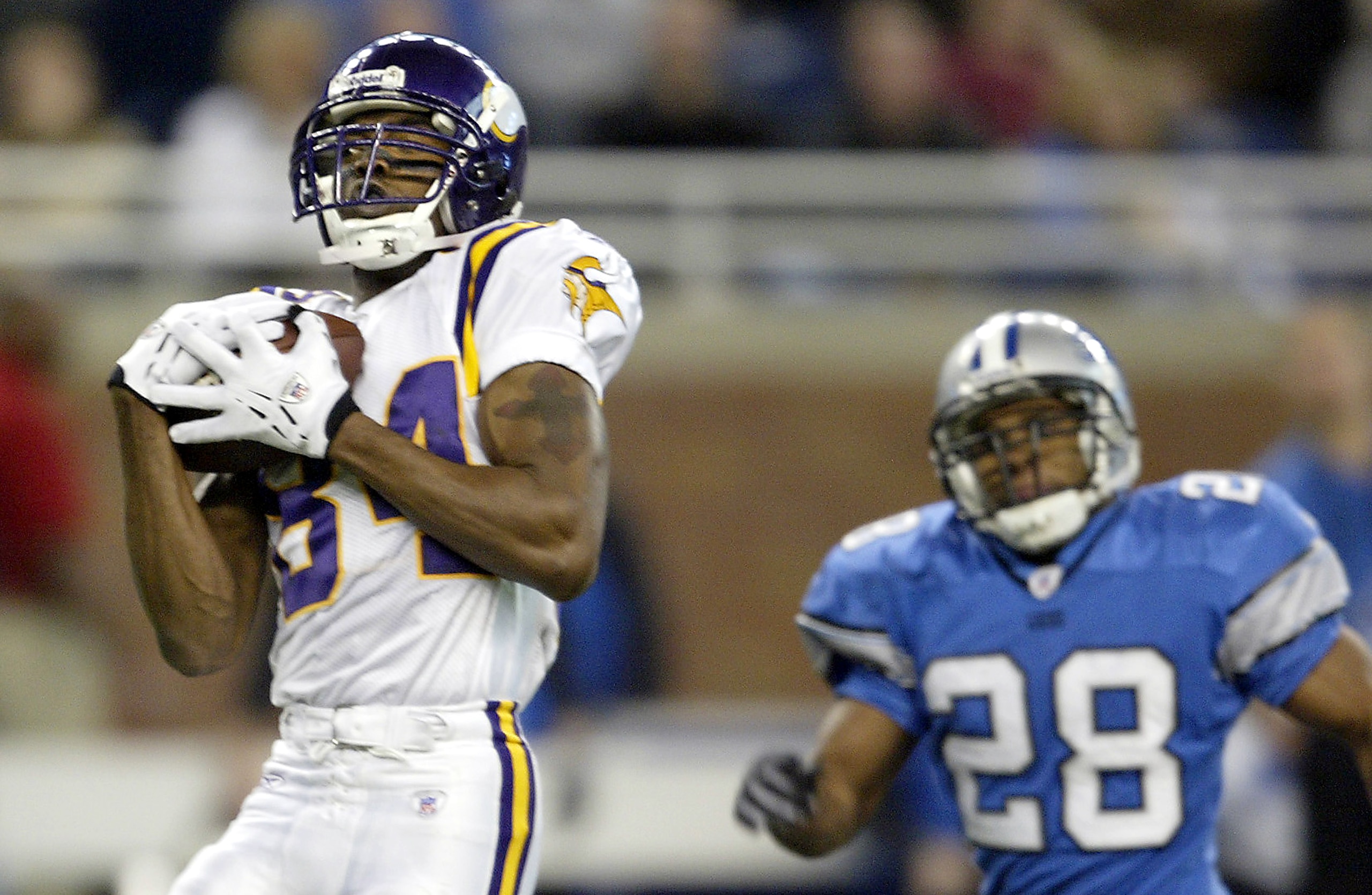 DETROIT - DECEMBER 19: Randy Moss #84 of the Minnesota Vikings receives a pass on his way to the end zone for an 82 yard touchdown reception against the Detroit Lions at Ford Field on December 19, 2004 in Detroit, Michigan. The Vikings won the game, 28-27