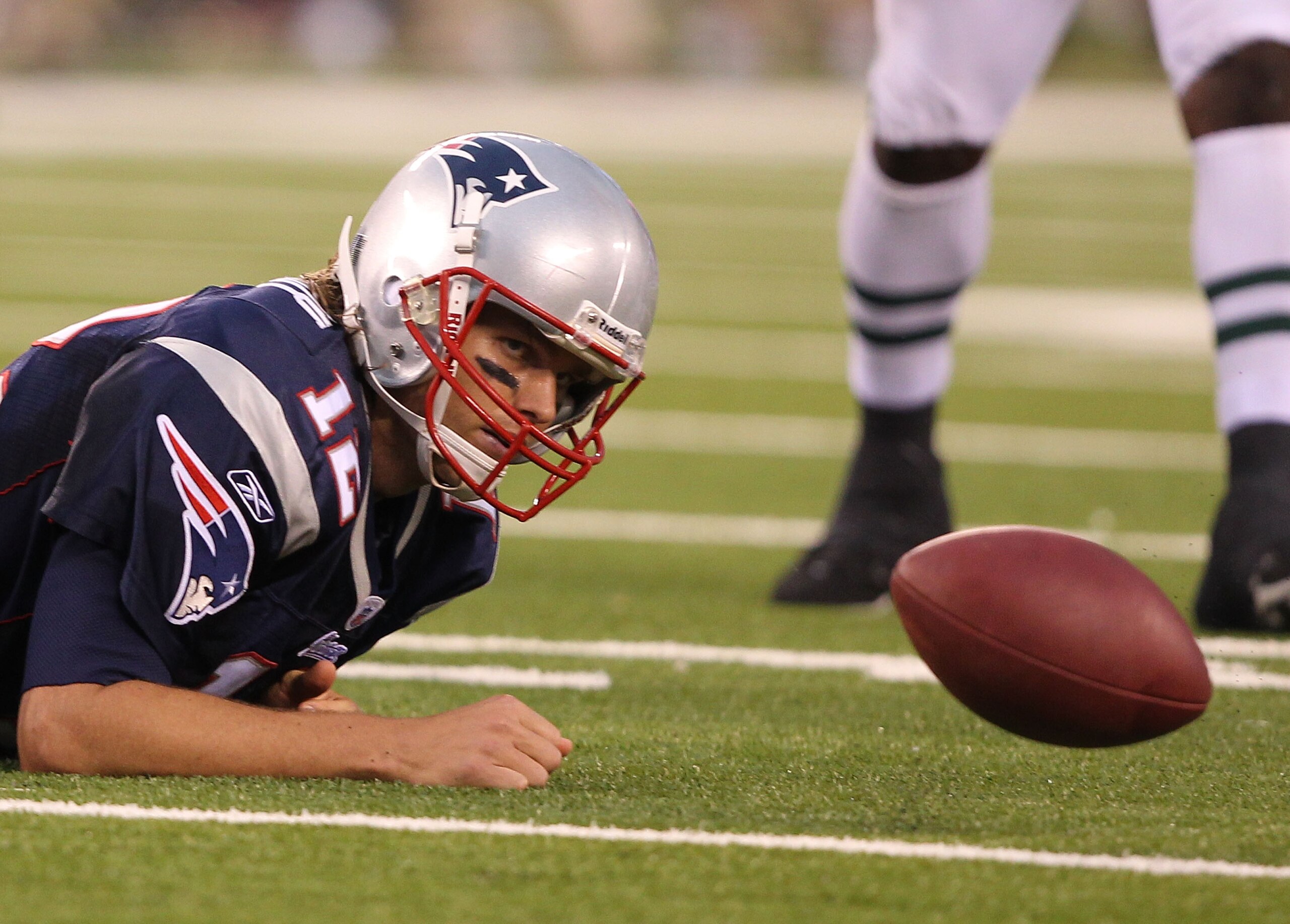 EAST RUTHERFORD, NJ - SEPTEMBER 19: Tom Brady #12 of the New England Patriots loses the ball after being sacked against  the New York Jets during their  game on September 19, 2010 at the New Meadowlands Stadium  in East Rutherford, New Jersey.  (Photo by 