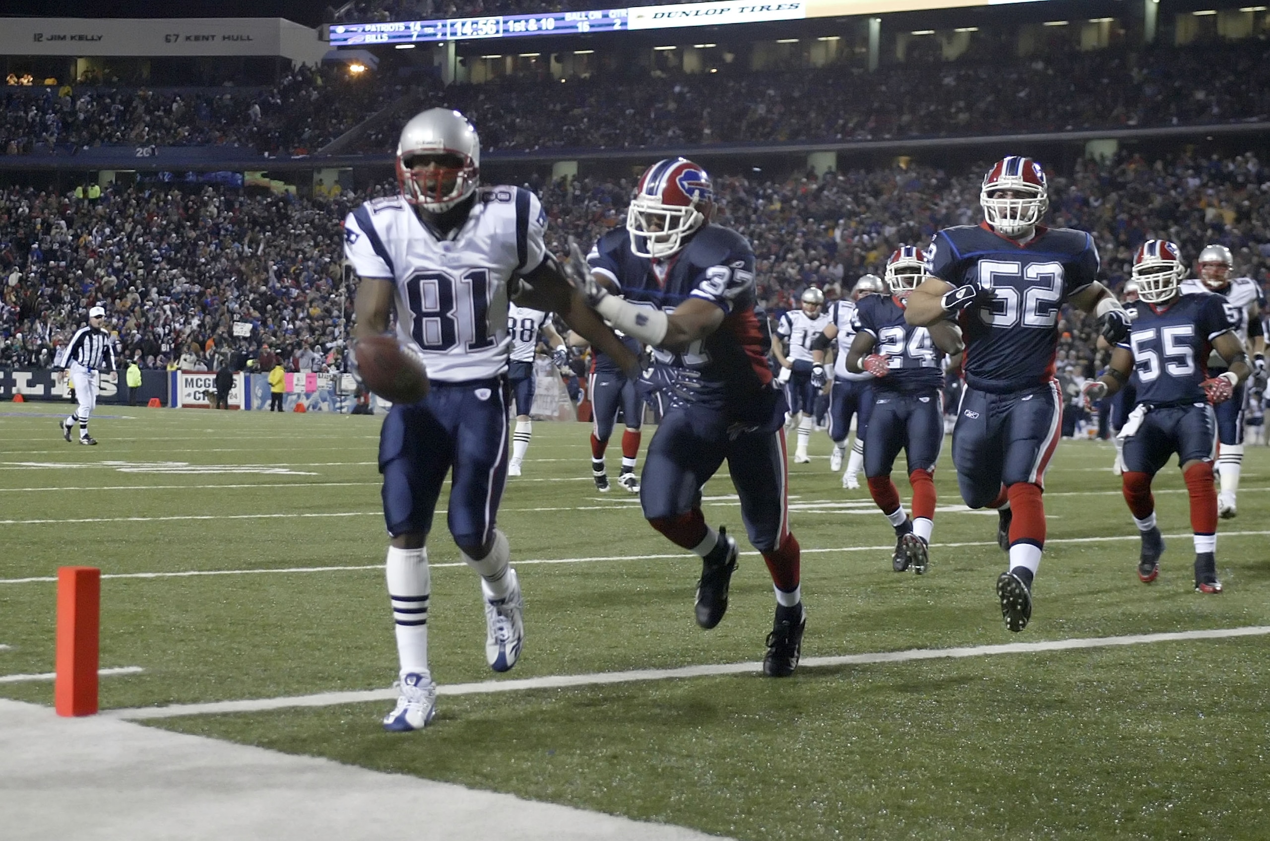 BUFFALO, NY - NOVEMBER 18:  Randy Moss #81 of the New England Patriots scores his third touchdown of the first half ahead of George Wilson #37 of the Buffalo Bills at Ralph Wilson Stadium November 18, 2007 in Orchard Park, New York.  (Photo by Rick Stewar