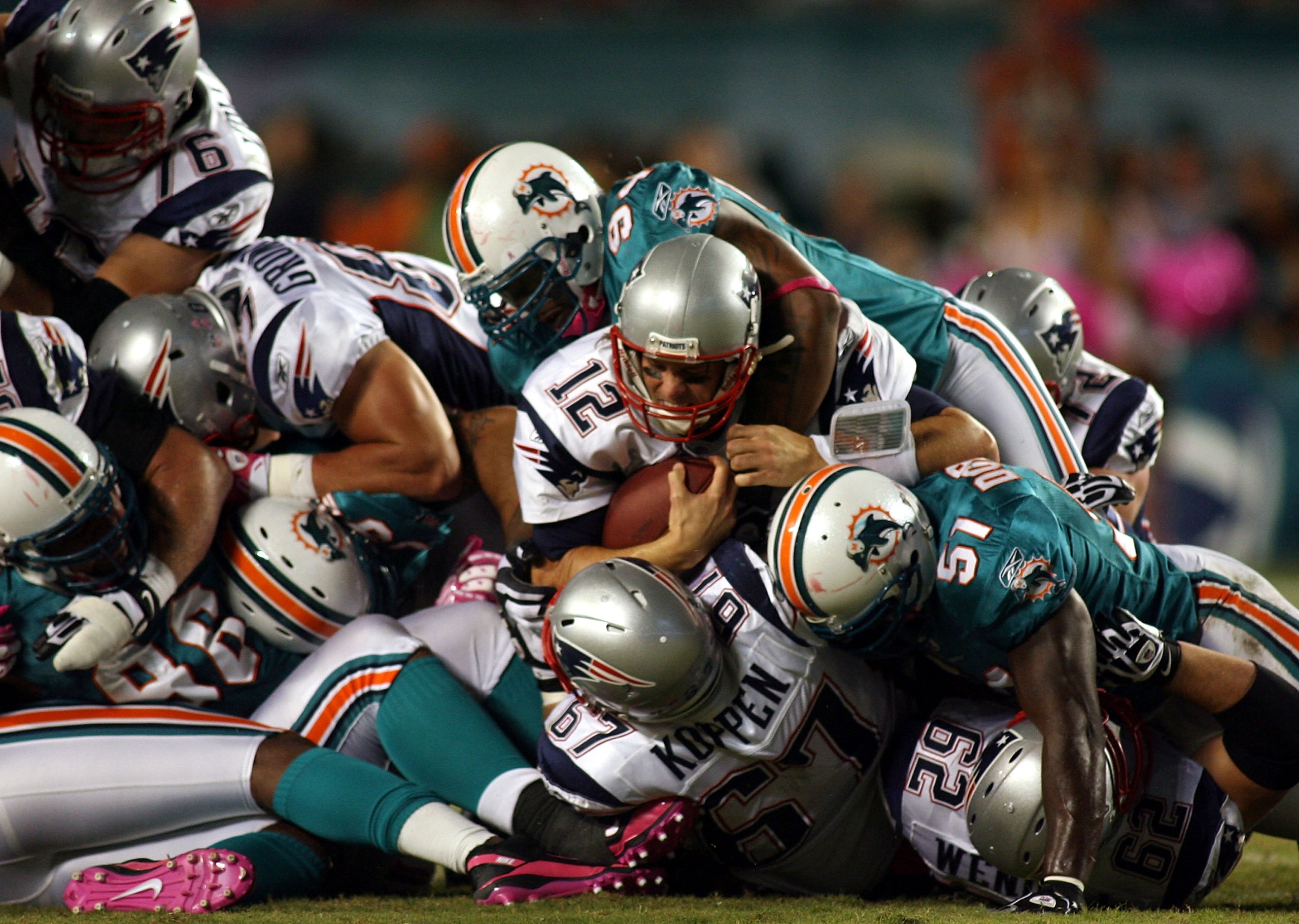 MIAMI - OCTOBER 04:  Quarterback Tom Brady #12 of the New England Patriots runs for a first down  against the Miami Dolphins at Sun Life Stadium on October 4, 2010 in Miami, Florida.  (Photo by Marc Serota/Getty Images)