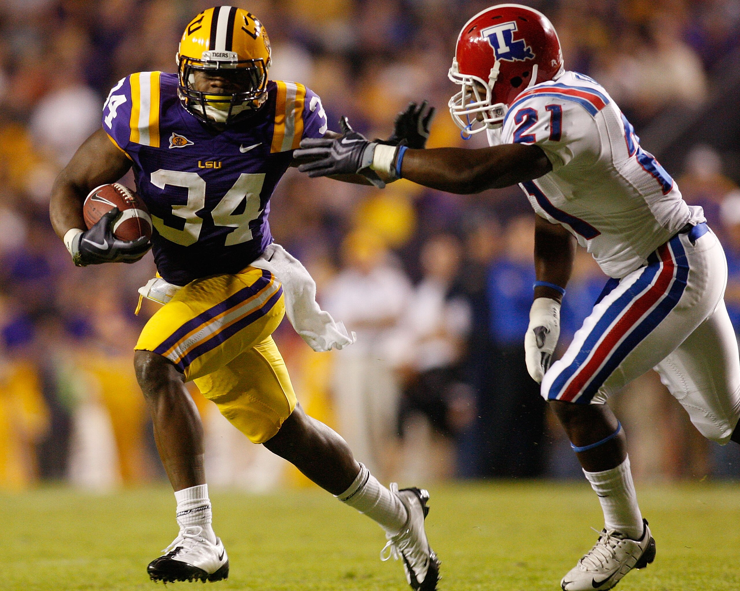 BATON ROUGE, LA - NOVEMBER 14: Stevan Ridley #34 of the LSU Tigers avoids a tackle by Dominique Faust #21 of the Louisiana Tech Bulldogs at Tiger Stadium on November 14, 2009 in Baton Rouge, Louisiana. The Tigers defeated the Bulldogs 24-16. (Photo by BATON ROUGE, LA - NOVEMBER 14: Stevan Ridley #34 of the LSU Tigers avoids a tackle by Dominique Faust #21 of the Louisiana Tech Bulldogs at Tiger Stadium on November 14, 2009 in Baton Rouge, Louisiana. The Tigers defeated the Bulldogs 24-16. (Photo by