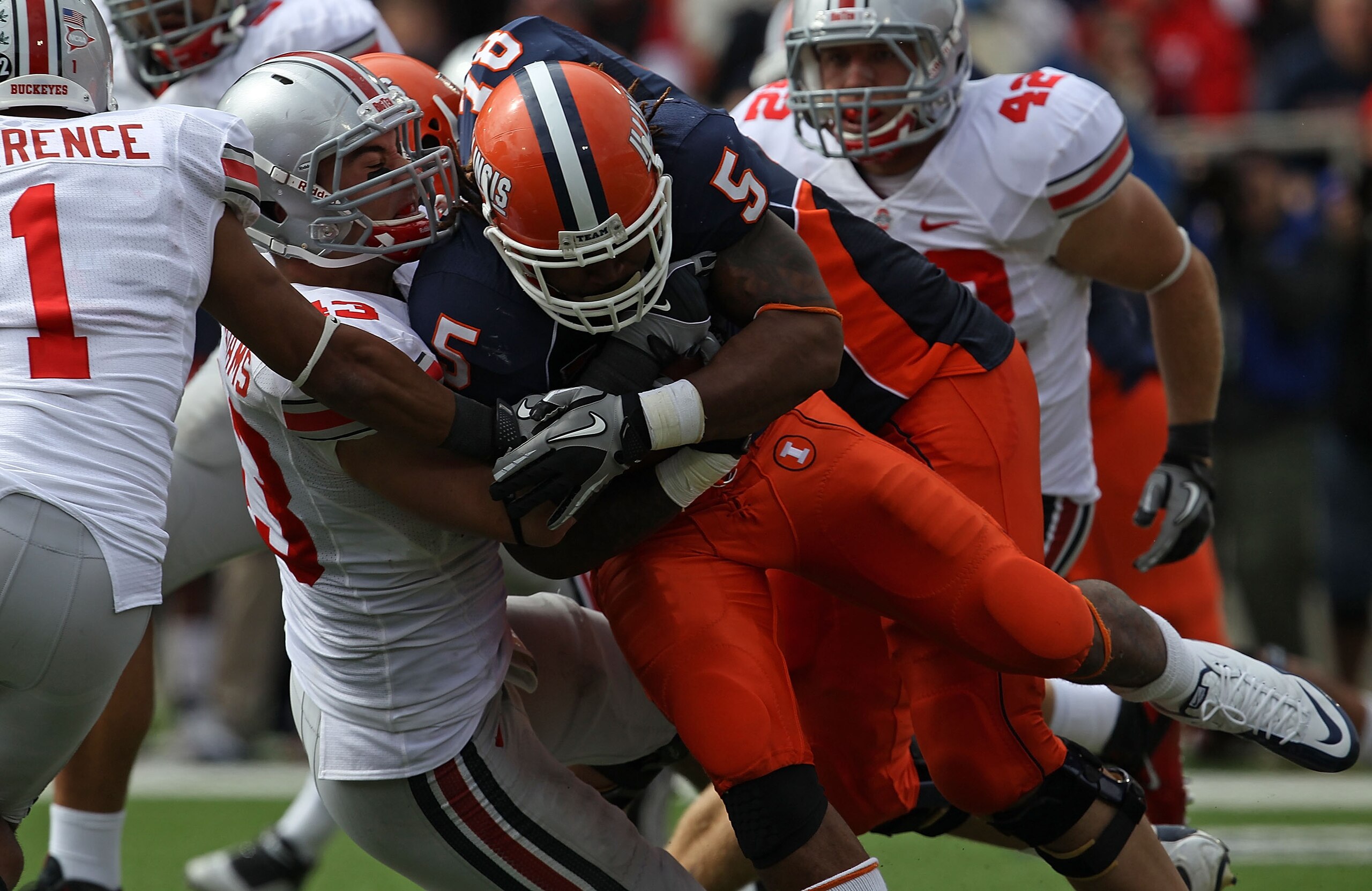 CHAMPAIGN, IL - OCTOBER 02: Nathan Williams #43 and Devon Torrence #1 of the Ohio State Buckeyes tackle Mikel Leshoure #5 of the Illinois Fighting Illini at Memorial Stadium on October 2, 2010 in Champaign, Illinois. Ohio State defeated Illinois 24-13. (P CHAMPAIGN, IL - OCTOBER 02: Nathan Williams #43 and Devon Torrence #1 of the Ohio State Buckeyes tackle Mikel Leshoure #5 of the Illinois Fighting Illini at Memorial Stadium on October 2, 2010 in Champaign, Illinois. Ohio State defeated Illinois 24-13. (P