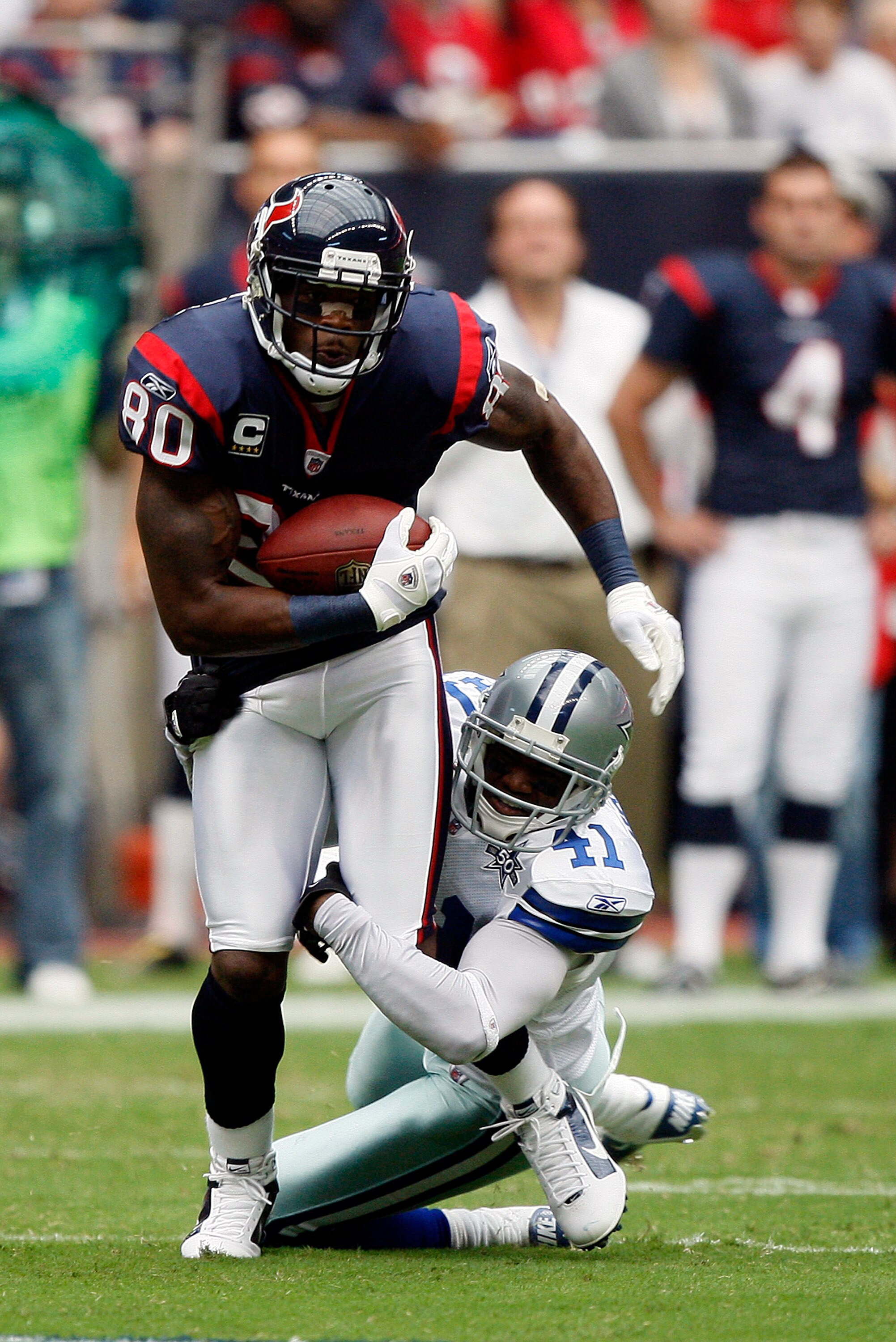 HOUSTON - SEPTEMBER 26:  Wide receiver Andre Johnson #80 of the Houston Texans attempts to shake the tackle of cornerback Terence Newman #41 of the Dallas Cowboys at Reliant Stadium on September 26, 2010 in Houston, Texas.  (Photo by Bob Levey/Getty Image