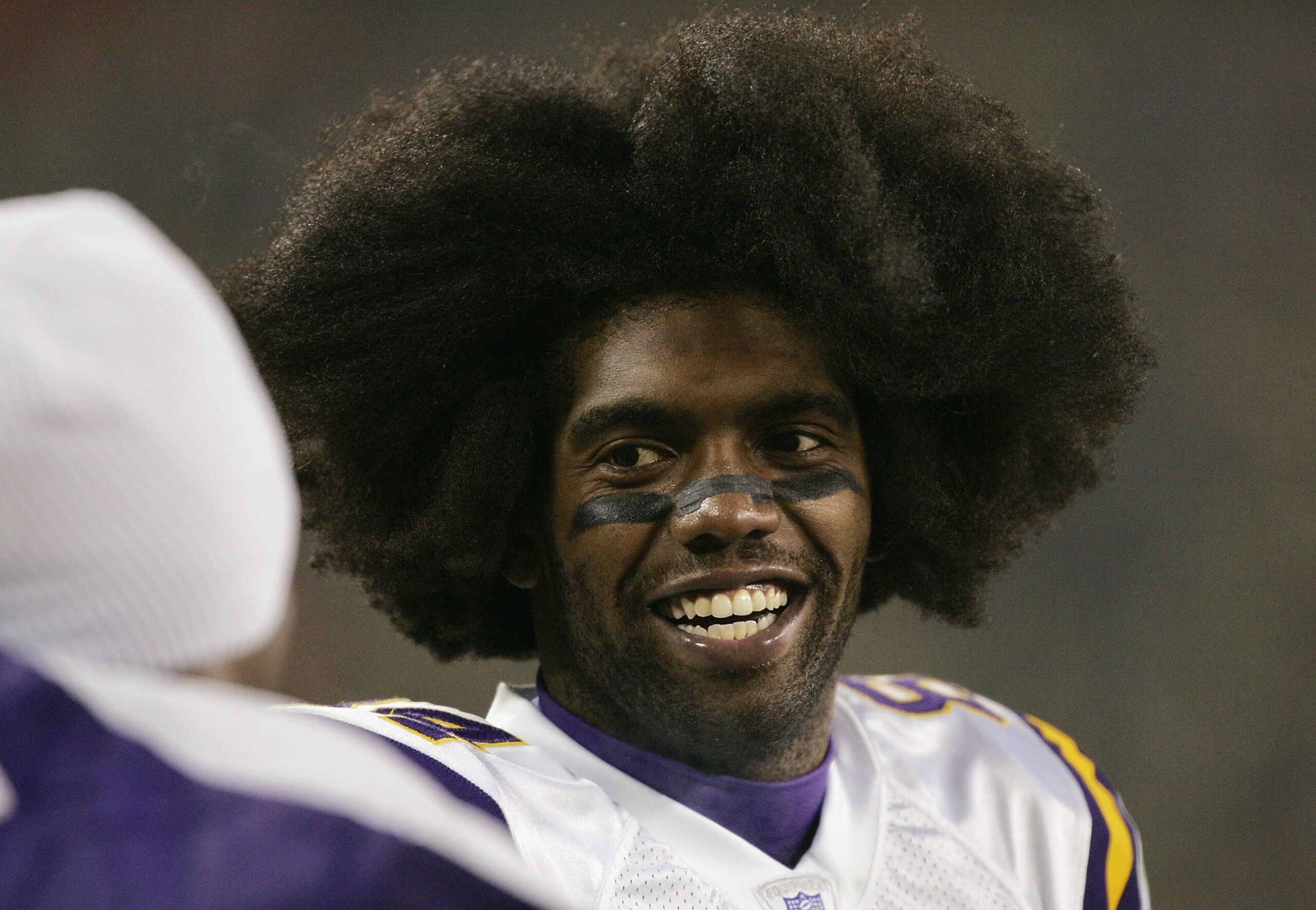 GREEN BAY, WI - JANUARY 9:  Wide receiver Randy Moss #84 of the Minnesota Vikings talks with a teammate against the Green Bay Packers in the NFC wild-card game at Lambeau Field on January 9, 2005 in Green Bay, Wisconsin.  The Vikings defeated the Packers 