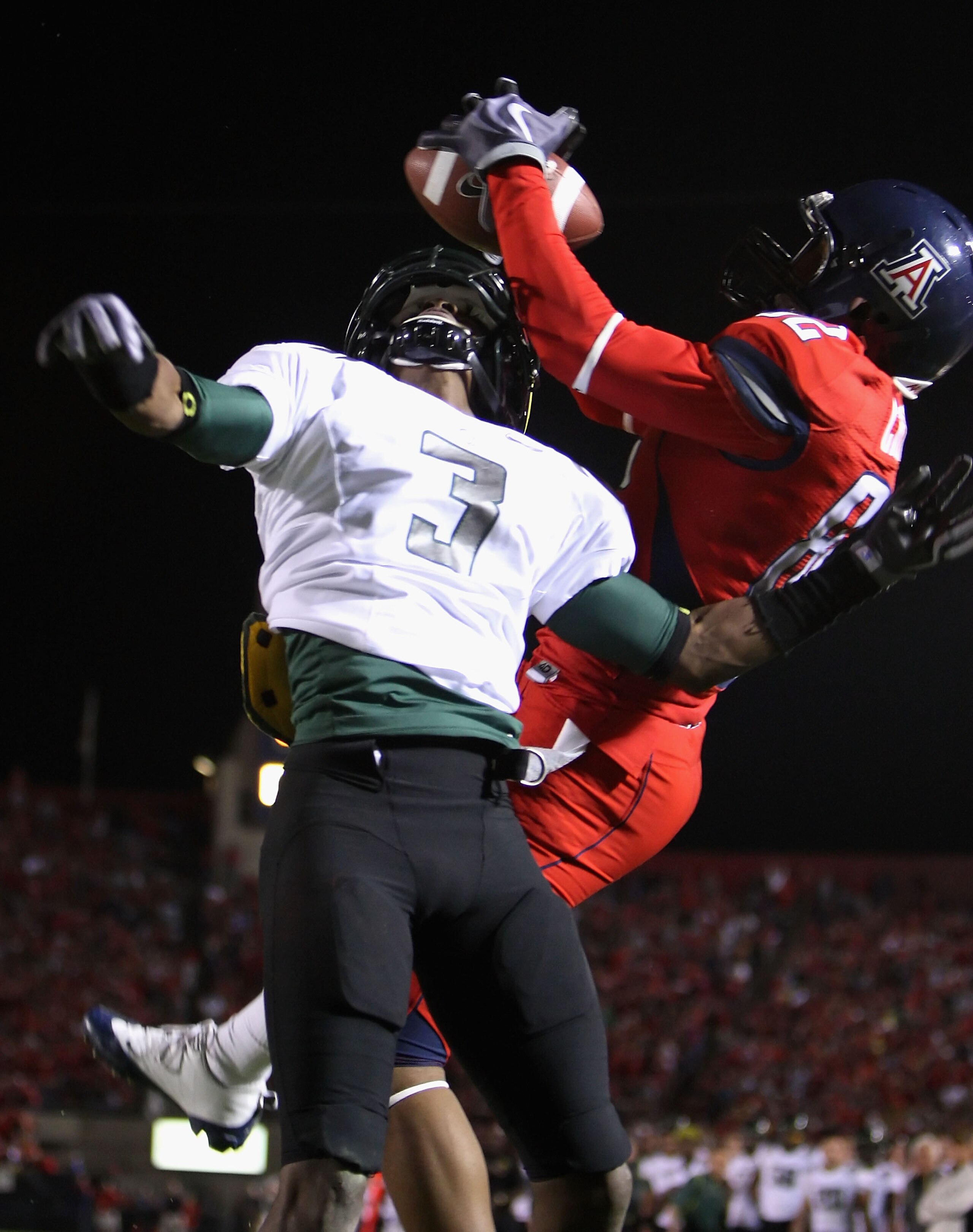 TUCSON, AZ - NOVEMBER 21:  Wide receiver Juron Criner #82 of the Arizona Wildcats catches a touchdown over Cliff Harris #3 of the Oregon Ducks during the seconnd quarter of the college football game at Arizona Stadium on November 21, 2009 in Tucson, Arizo