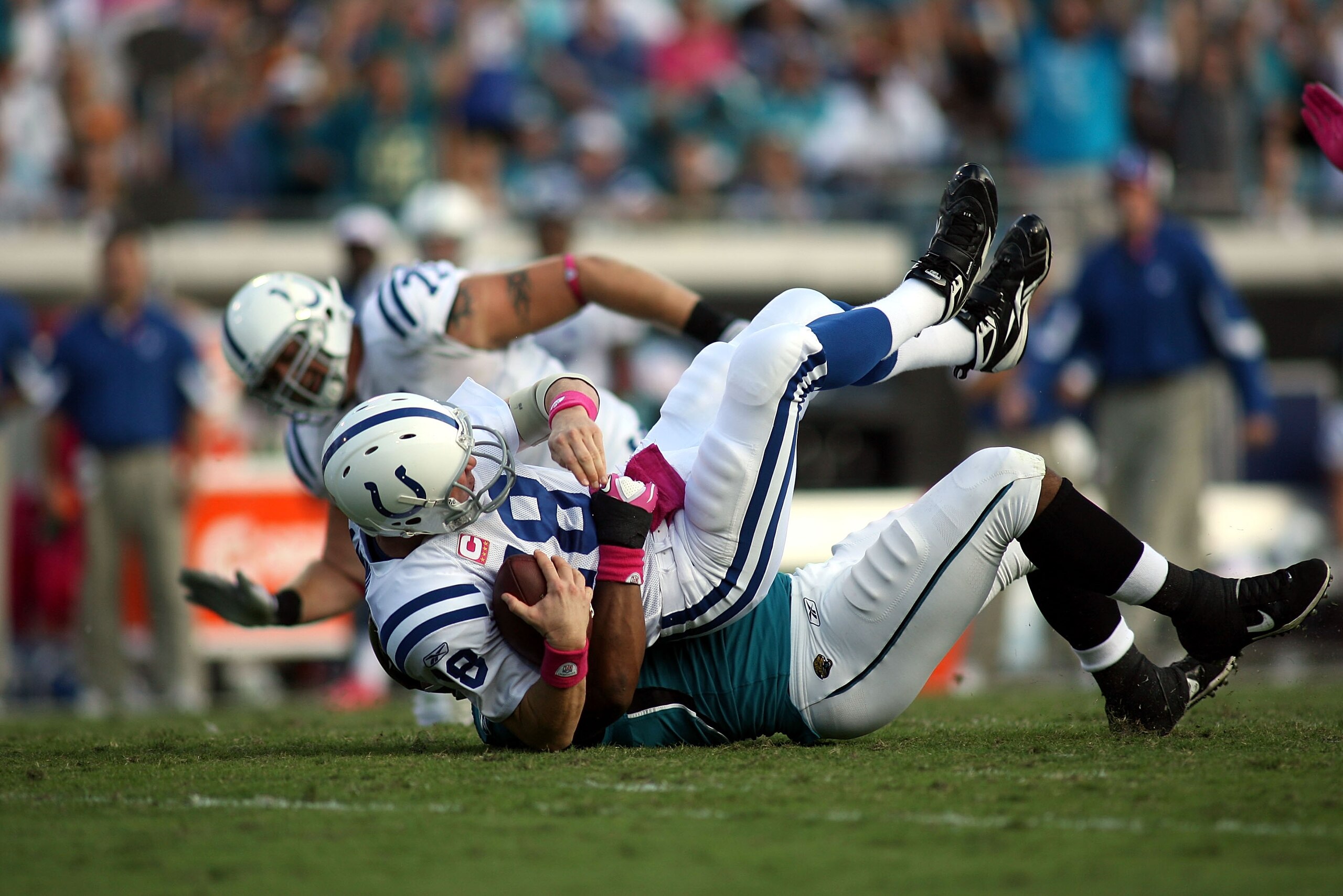 JACKSONVILLE, FL - OCTOBER 03:  Quarterback Peyton Manning #18 of the Indianapolis Colts is sacked by Lineman Jeremy Mincey #94 of the Jacksonville Jaguars at EverBank Field on October 3, 2010 in Jacksonville, Florida. The Jaguars won 31-28.  (Photo by Ma
