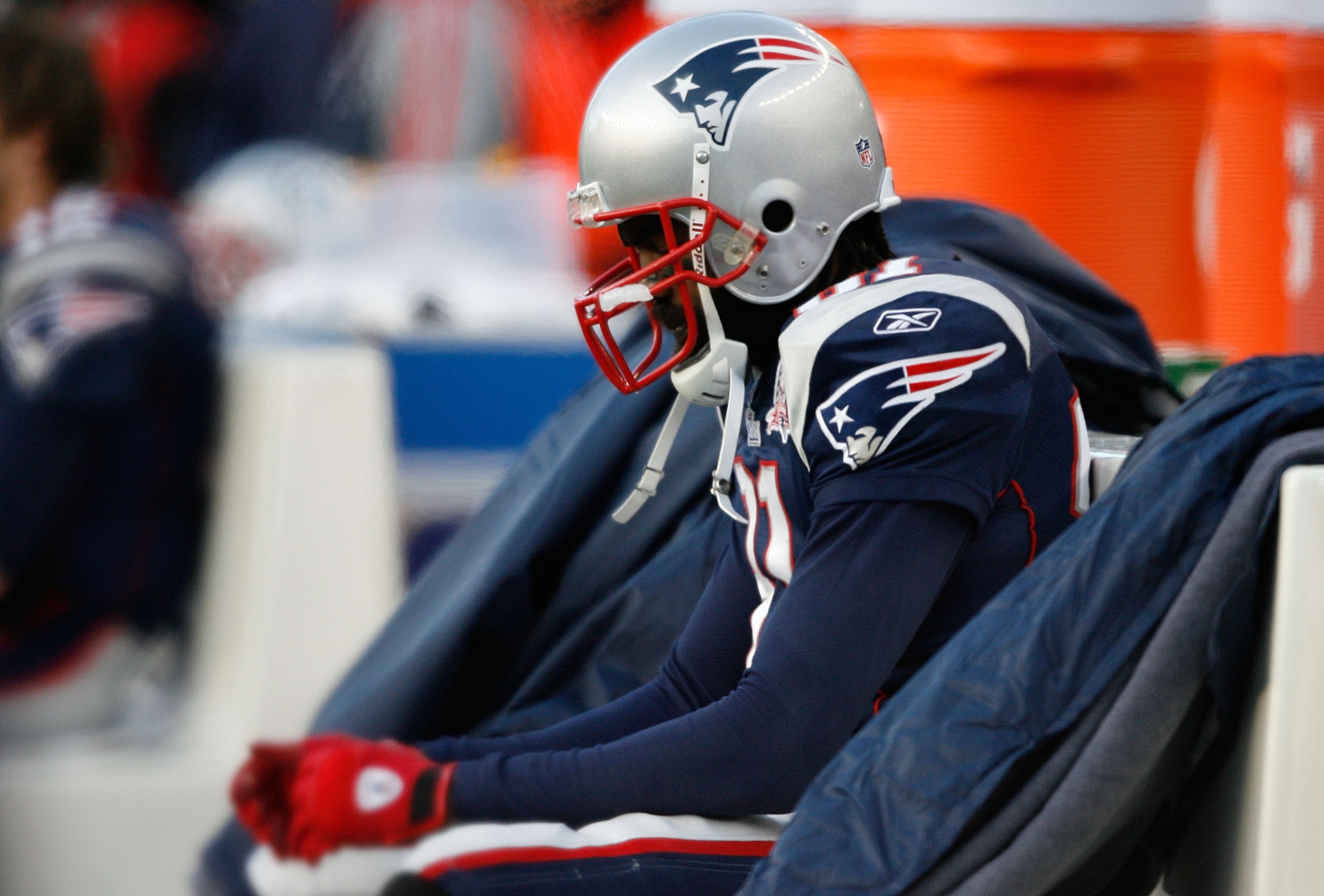 FOXBORO, MA - JANUARY 10:  Randy Moss #81 of the New England Patriots sits on the bench dejected late in the fourth quarter against the Baltimore Ravens during the 2010 AFC wild-card playoff game at Gillette Stadium on January 10, 2010 in Foxboro, Massach