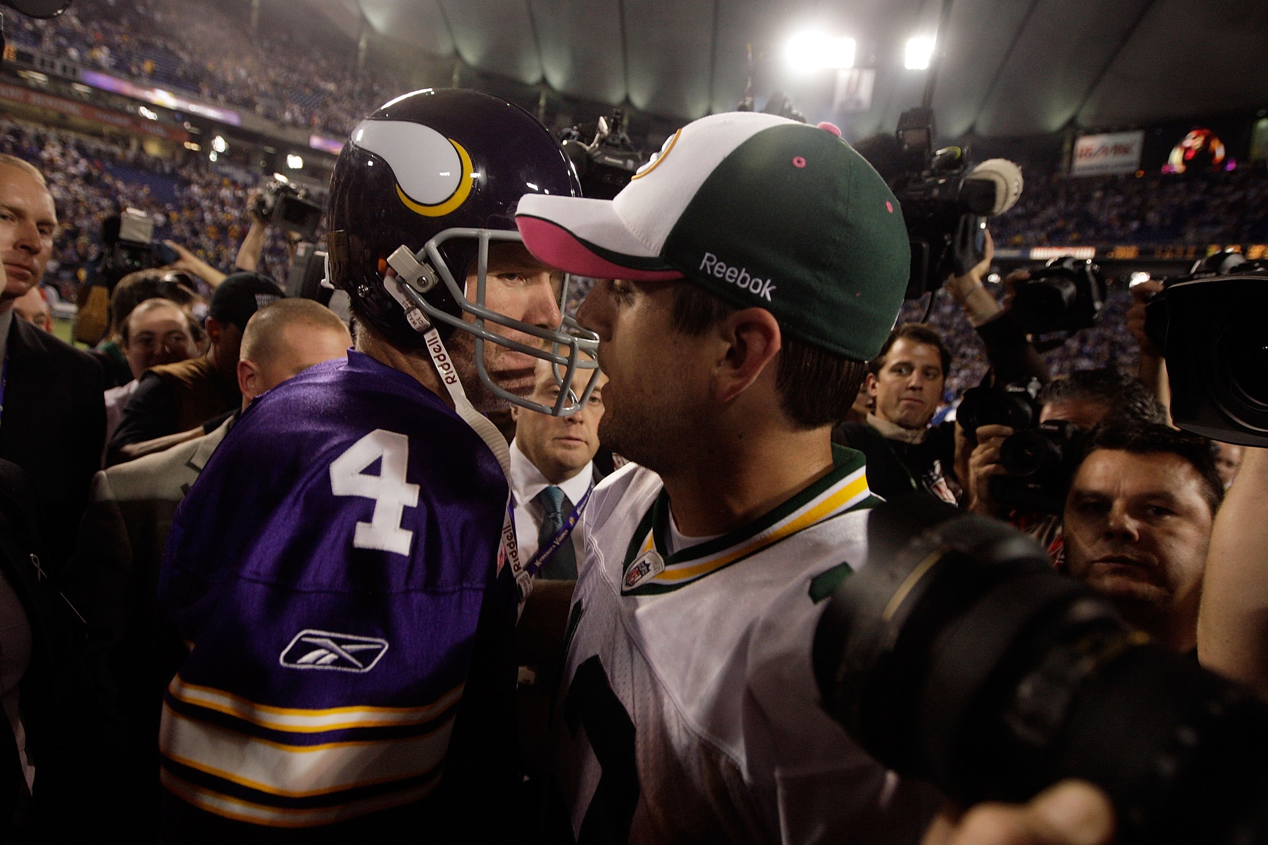 MINNEAPOLIS - OCTOBER 05:  Quarterback Brett Favre #4 of the Minnesota Vikings hugs Aaron Rodgers #12 of the Green Bay Packers following the Vikings victory over the Packers on October 5, 2009 at Hubert H. Humphrey Metrodome in Minneapolis, Minnesota.  (P