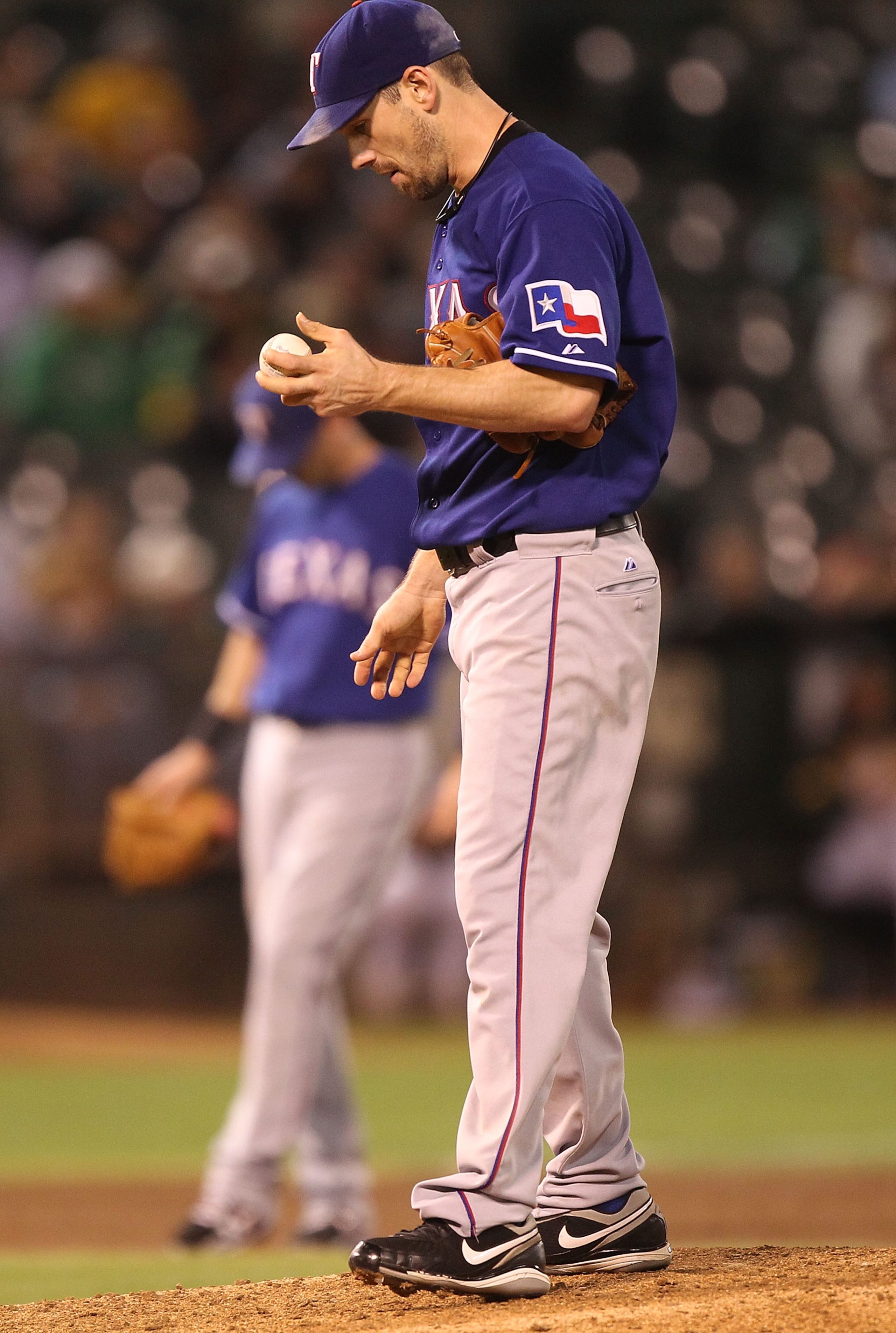 OAKLAND, CA - SEPTEMBER 23:  Cliff Lee #33 of the Texas Rangers looks on after giving up two runs to the Oakland Athletics in the fifth inning during a Major League Baseball game at the Oakland-Alameda County Coliseum on September 23, 2010 in Oakland, Cal