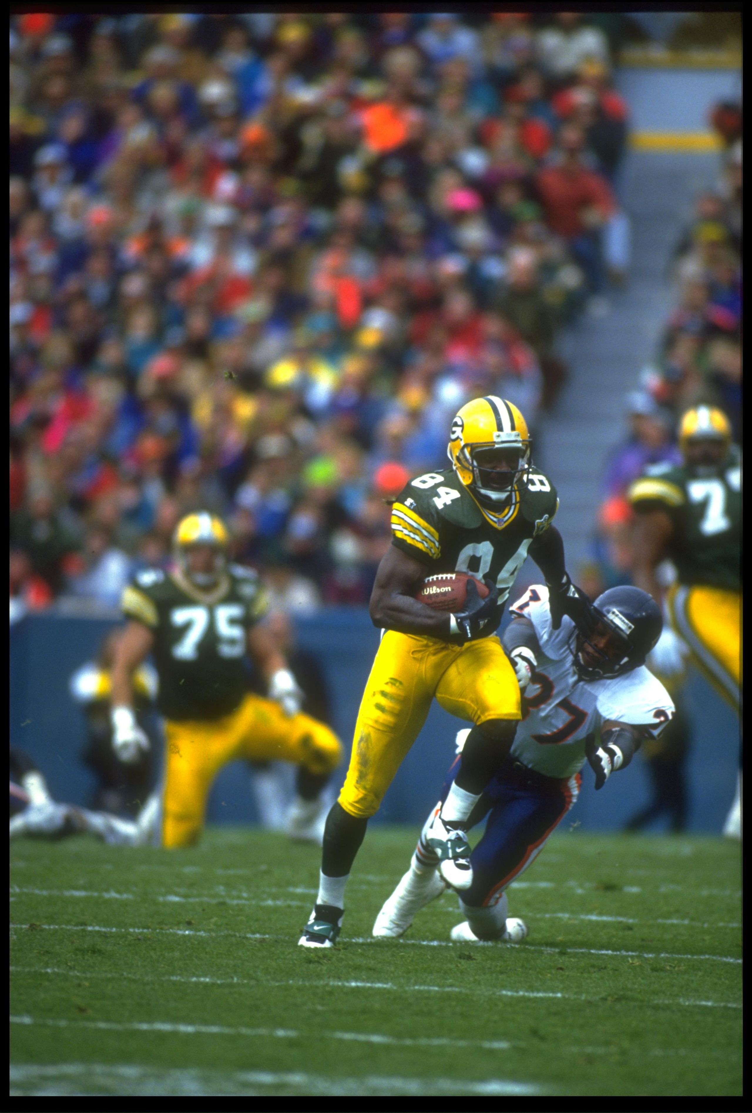 31 OCT 1993:  GREEN BAY PACKERS WIDE RECEIVER STERLING SHARPE GIVES A STRAIGHT ARM TO AN UNIDENTIFIED CHICAGO BEARS DEFENSEMAN DURING THE PACKERS 17-3 WIN AT LAMBEAU FIELD IN CHICAGO, ILLINOIS.  MANDATORY CREDIT:  JONATHAN DANIEL/ALLSPORT