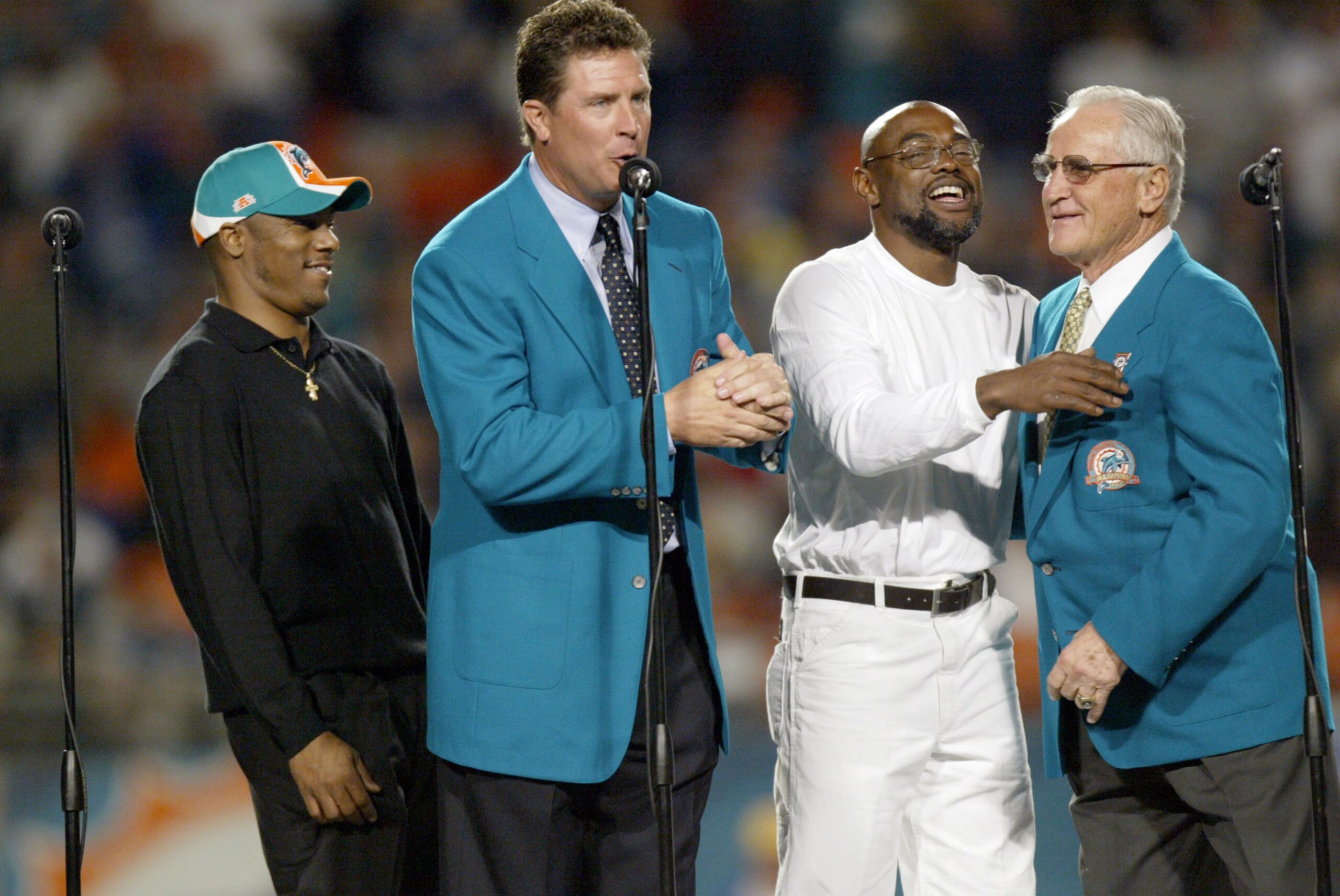 MIAMI - DECEMBER 15:  Former Miami Dolphins Quarterback Dan Marino (2nd-L) inducts into the Miami Dolphins Hall of Fame Mark Clayton (L) and Mark Duper with the help of Coach Don Shula (R) during half time against the Philadelphia Eagles on December 15, 2