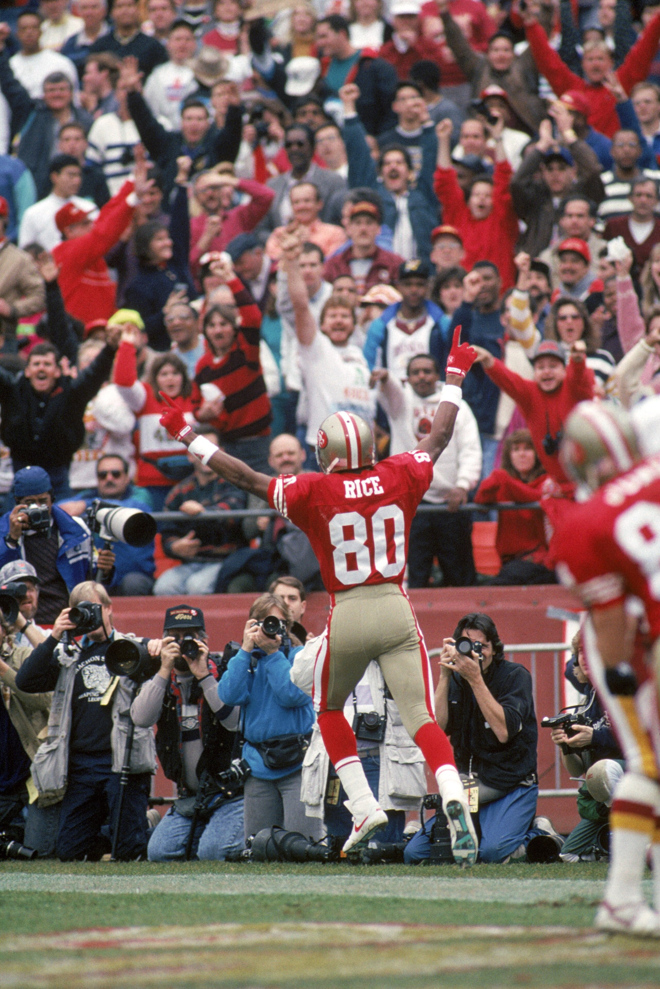 SAN FRANCISCO - JANUARY 12:  Wide receiver Jerry Rice #80 of the San Francisco 49ers celebrates a 10-yard touchdown pass from Joe Montana in the second quarter in the 1990 NFC Divisional Playoff game against the Washington Redskins at Candlestick Park on