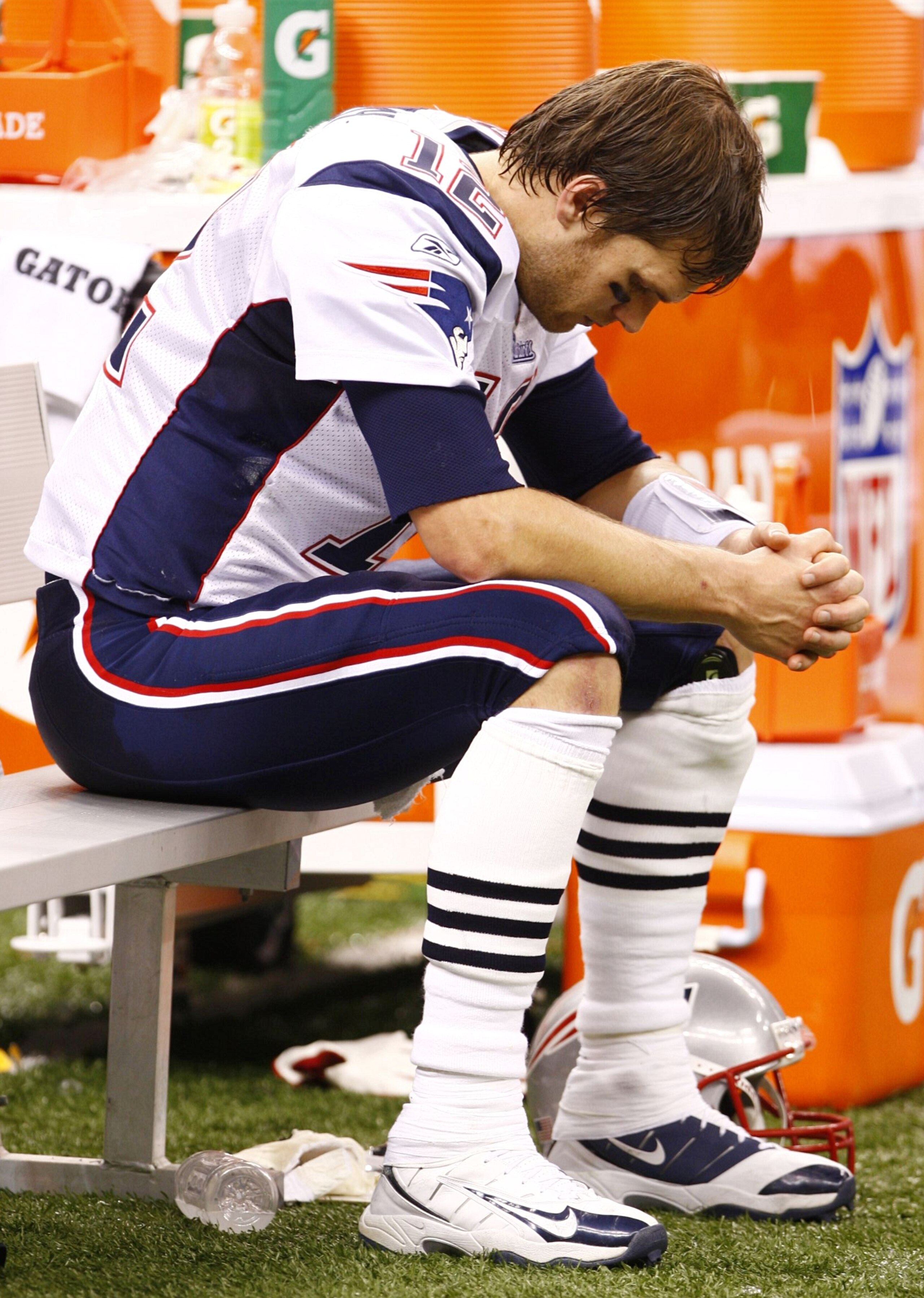 NEW ORLEANS - NOVEMBER 30: Quarterback Tom Brady #12 of the New England Patriots sits dejected on the bench late in the fourth quarter against the New Orleans Saints at Louisana Superdome on November 30, 2009 in New Orleans, Louisiana. (Photo by Scott Hal