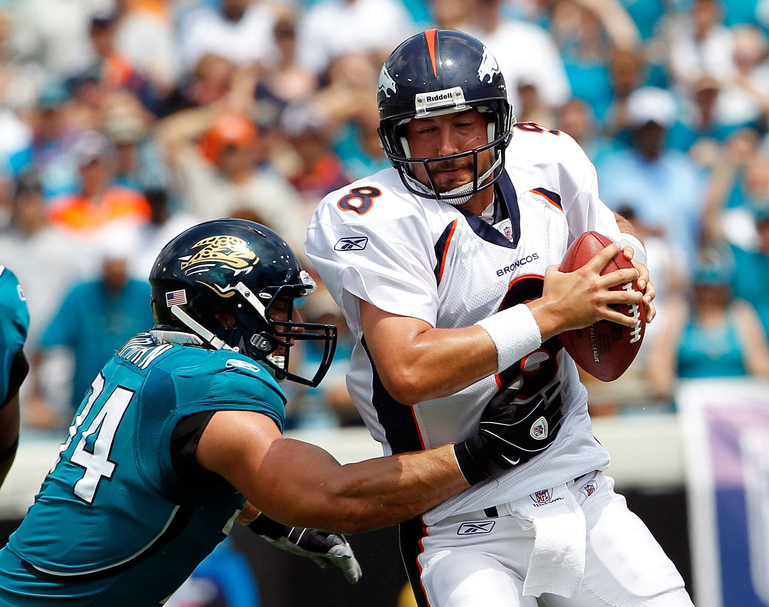 JACKSONVILLE, FL - SEPTEMBER 12:  Aaron Kampman #74 of the Jacksonville Jaguars attempts to tackle Quarterback Kyle Orton #8 of the Denver Broncos during the NFL season opener game at EverBank Field on September 12, 2010 in Jacksonville, Florida.  (Photo
