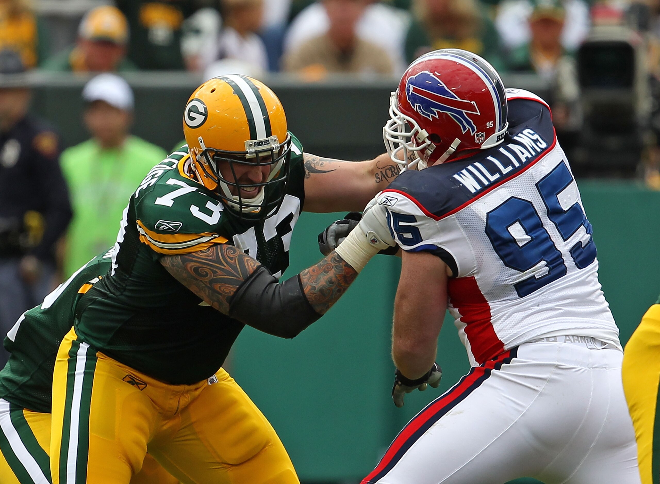 GREEN BAY, WI - SEPTEMBER 19: Daryn Colledge #73 of the Green Bay Packers blocks Kyle Williams #95 of the Buffalo Bills at Lambeau Field on September 19, 2010 in Green Bay, Wisconsin. The Packers defeated the Bills 34-7. (Photo by Jonathan Daniel/Getty Im