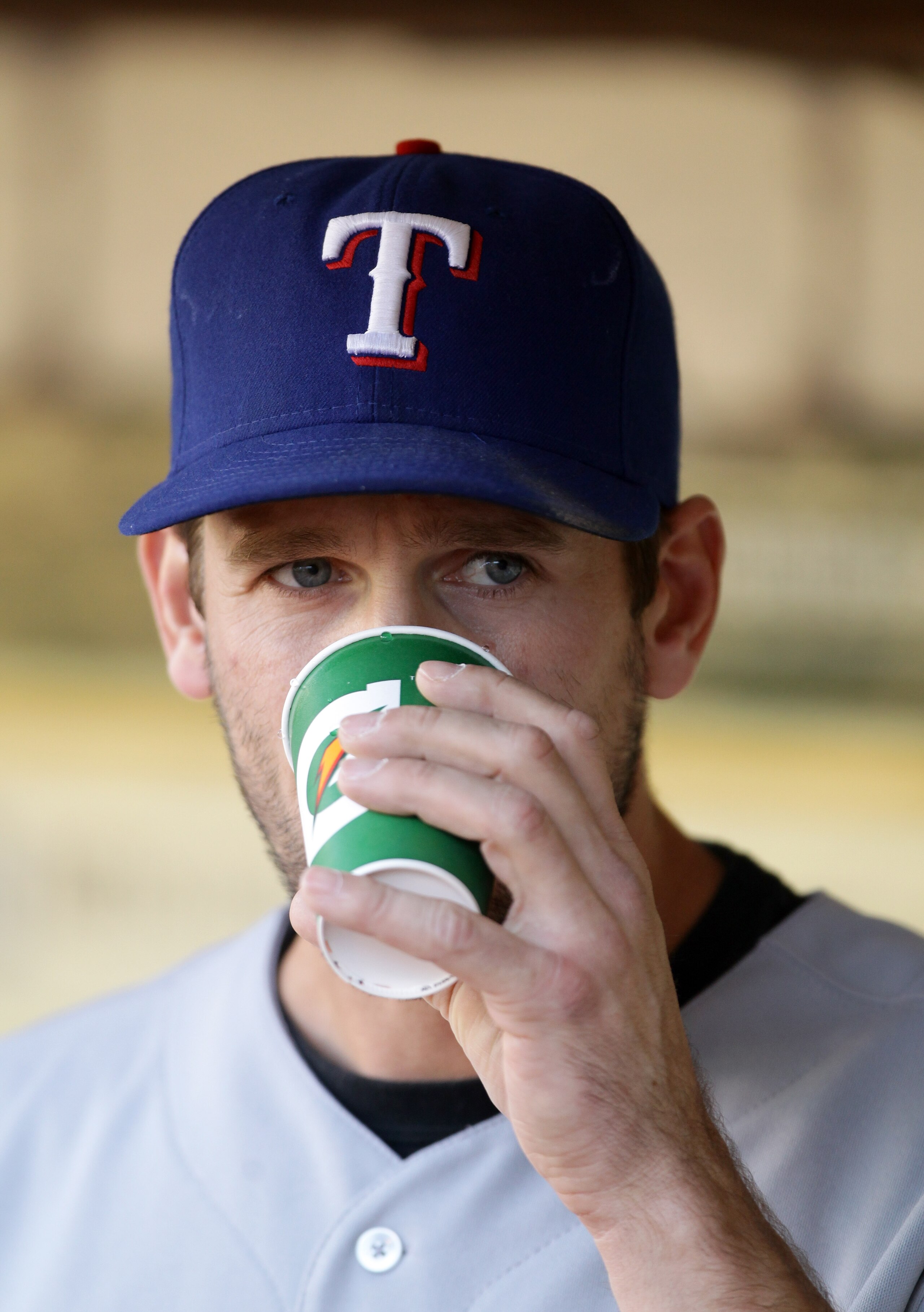 OAKLAND, CA - AUGUST 06:  Cliff Lee #33 of the Texas Rangers drinks Gatorade in the dugout before their game against the Oakland Athletics at the Oakland-Alameda County Coliseum on August 6, 2010 in Oakland, California.  (Photo by Ezra Shaw/Getty Images)