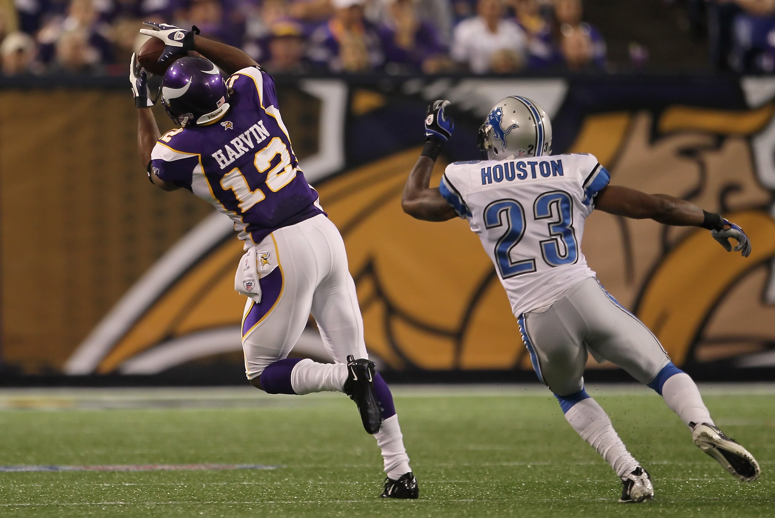 MINNEAPOLIS - SEPTEMBER 26: Wide receiver Percy Harvin #12 of the Minnesota Vikings makes a catch for a reception in front of Chris Houston #23 of the Detroit Lions during the first half at Hubert H. Humphrey Metrodome on September 26, 2010 in Minneapoli MINNEAPOLIS - SEPTEMBER 26: Wide receiver Percy Harvin #12 of the Minnesota Vikings makes a catch for a reception in front of Chris Houston #23 of the Detroit Lions during the first half at Hubert H. Humphrey Metrodome on September 26, 2010 in Minneapoli