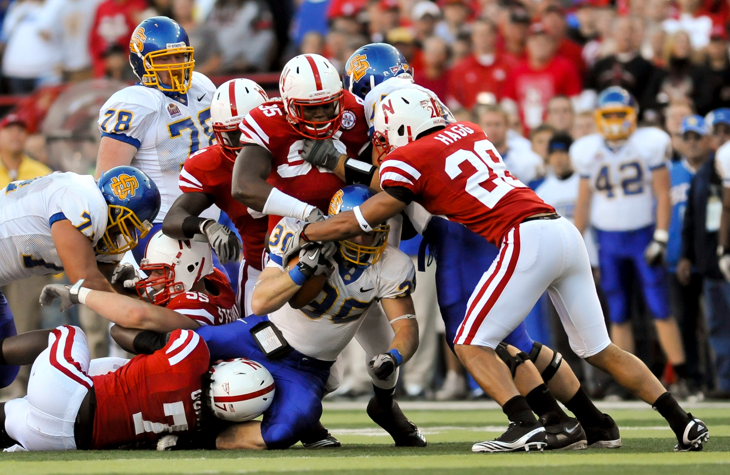 LINCOLN, NEBRASKA - SEPTEMBER 25: The Nebraska Cornhusker defense swarms South Dakota State Jackrabbits running back Kyle Minett #30 during first half action of their game at Memorial Stadium on September 25, 2010 in Lincoln, Nebraska. Nebraska Defeated S LINCOLN, NEBRASKA - SEPTEMBER 25: The Nebraska Cornhusker defense swarms South Dakota State Jackrabbits running back Kyle Minett #30 during first half action of their game at Memorial Stadium on September 25, 2010 in Lincoln, Nebraska. Nebraska Defeated S