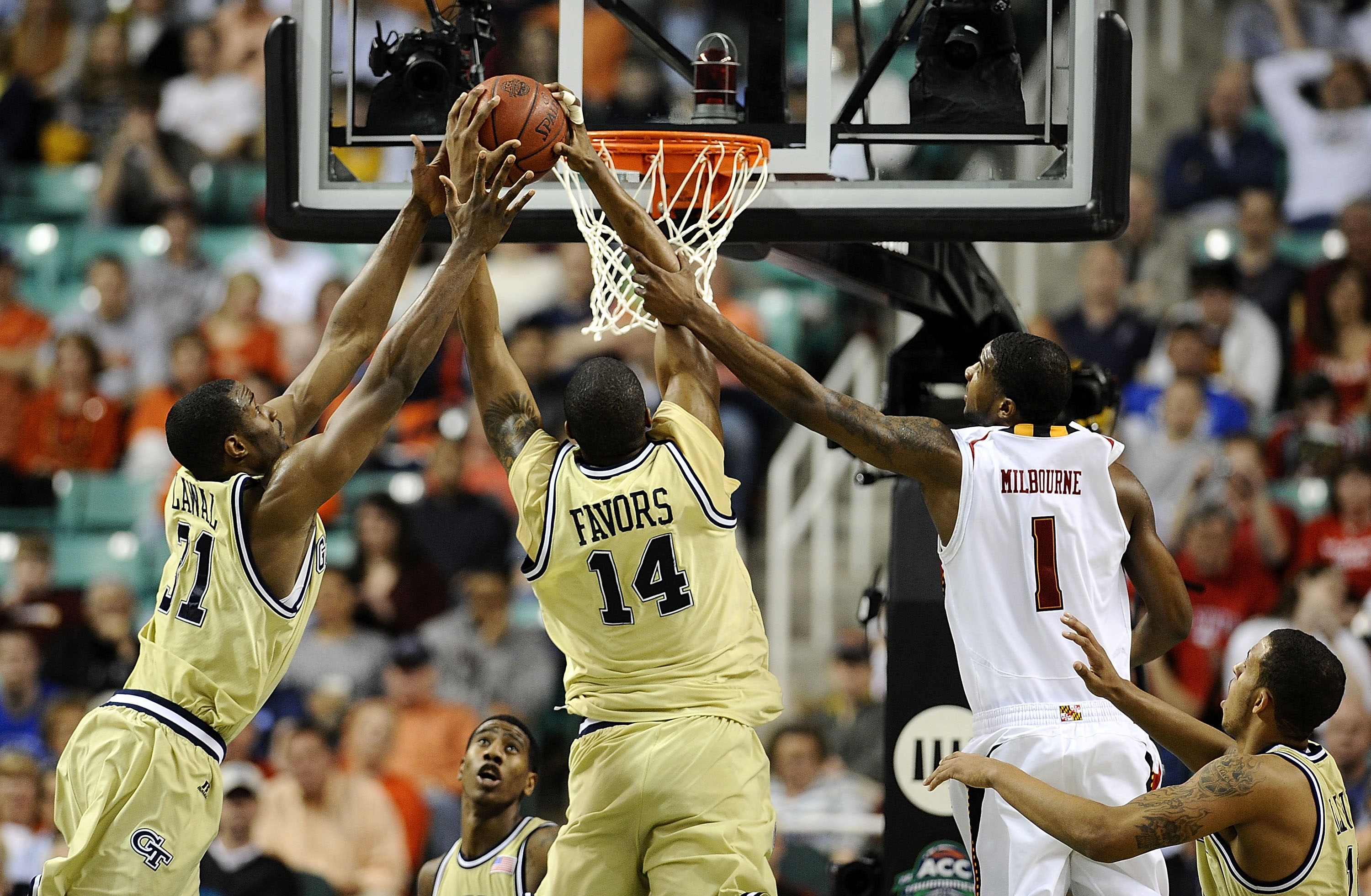 GREENSBORO, NC - MARCH 12:  Derrick Favors #14 and Gani Lawal #31 of the Georgia Tech Yellow Jackets shoots between grab a loose ball from Landon Milbourne #01 the University of Maryland Terrapins in their quarterfinal game in the 2010 ACC Men's Basketbal