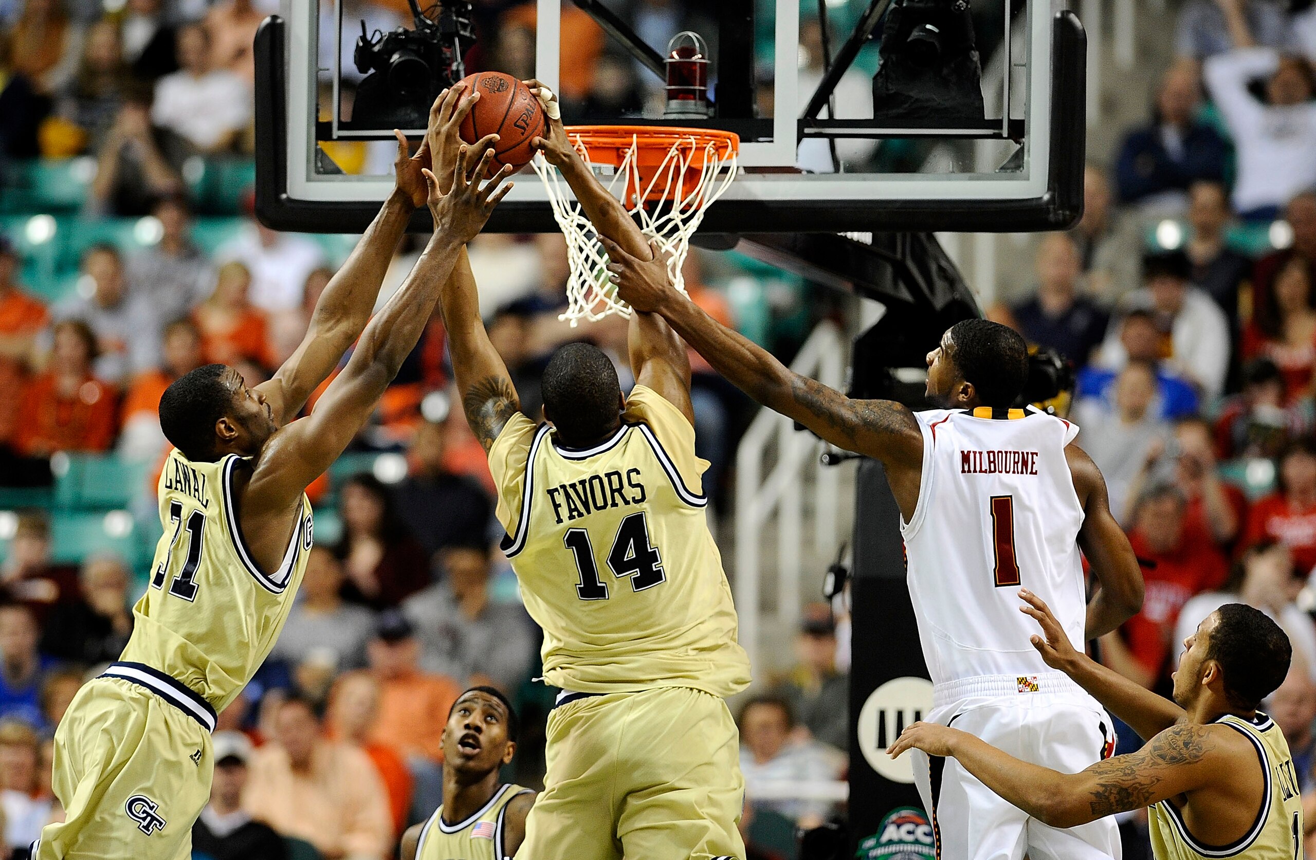 GREENSBORO, NC - MARCH 12:  Derrick Favors #14 and Gani Lawal #31 of the Georgia Tech Yellow Jackets shoots between grab a loose ball from Landon Milbourne #01 the University of Maryland Terrapins in their quarterfinal game in the 2010 ACC Men's Basketbal