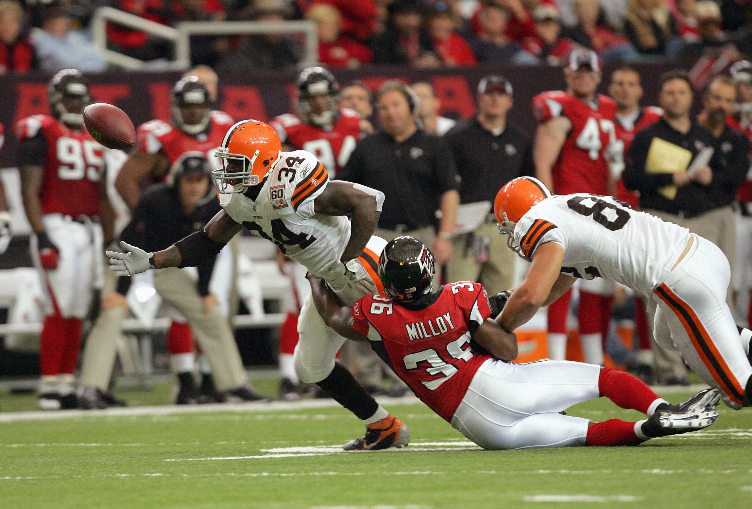 ATLANTA - NOVEMBER 12: Lawyer Milloy #36  of the Atlanta Falcons grabs Reuben Droughns #34 of the Cleveland Browns at the Georgia Dome November 12, 2006 in Atlanta, Georgia. (Photo by Streeter Lecka/Getty Images)